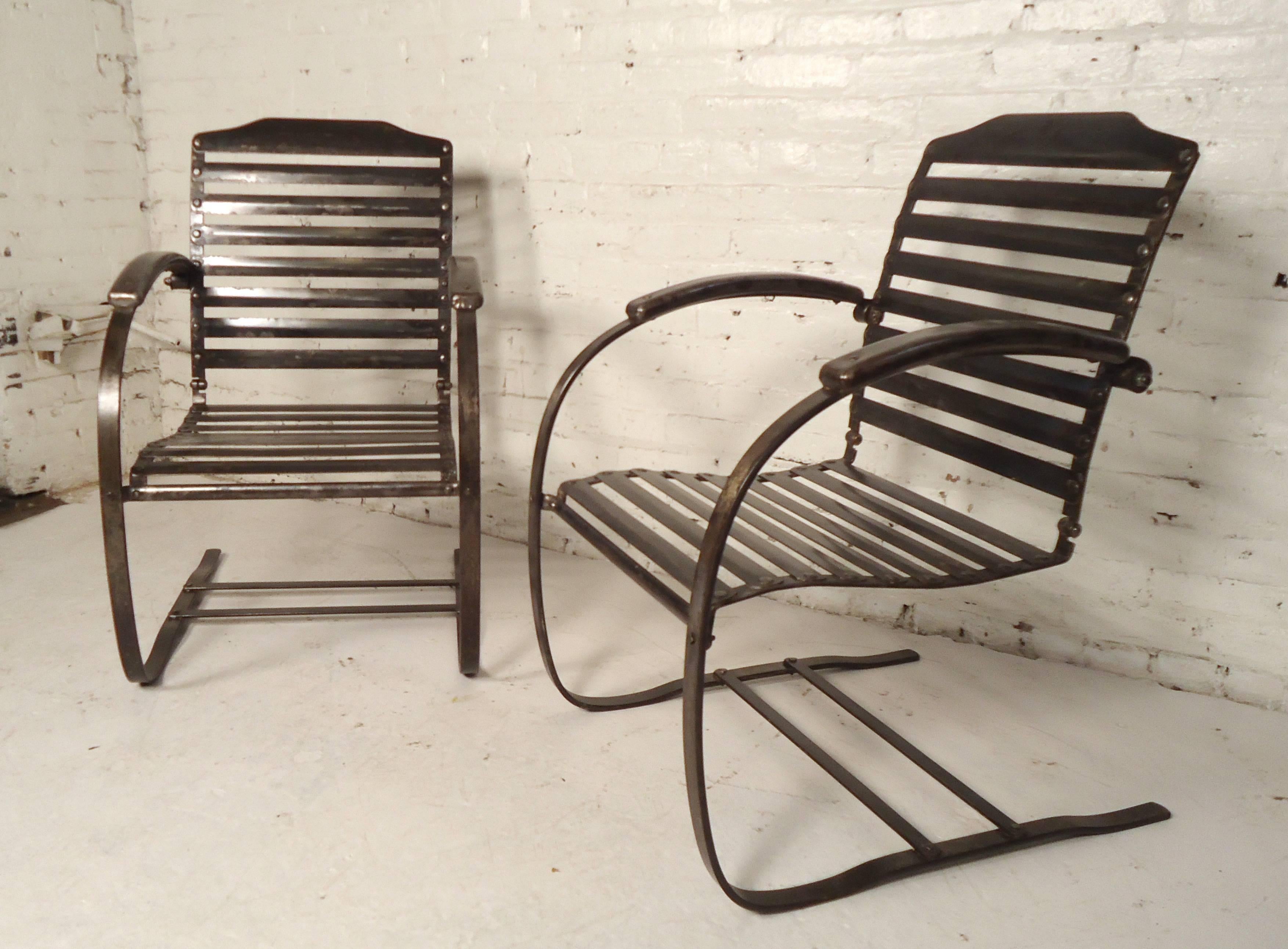 This vintage pair of patio chairs features sturdy metal construction with horizontal slat seat and back. Rounded cantilever spring style frames make a stylish impression for any home, garden or patio. 

Please confirm item location (NY or NJ).