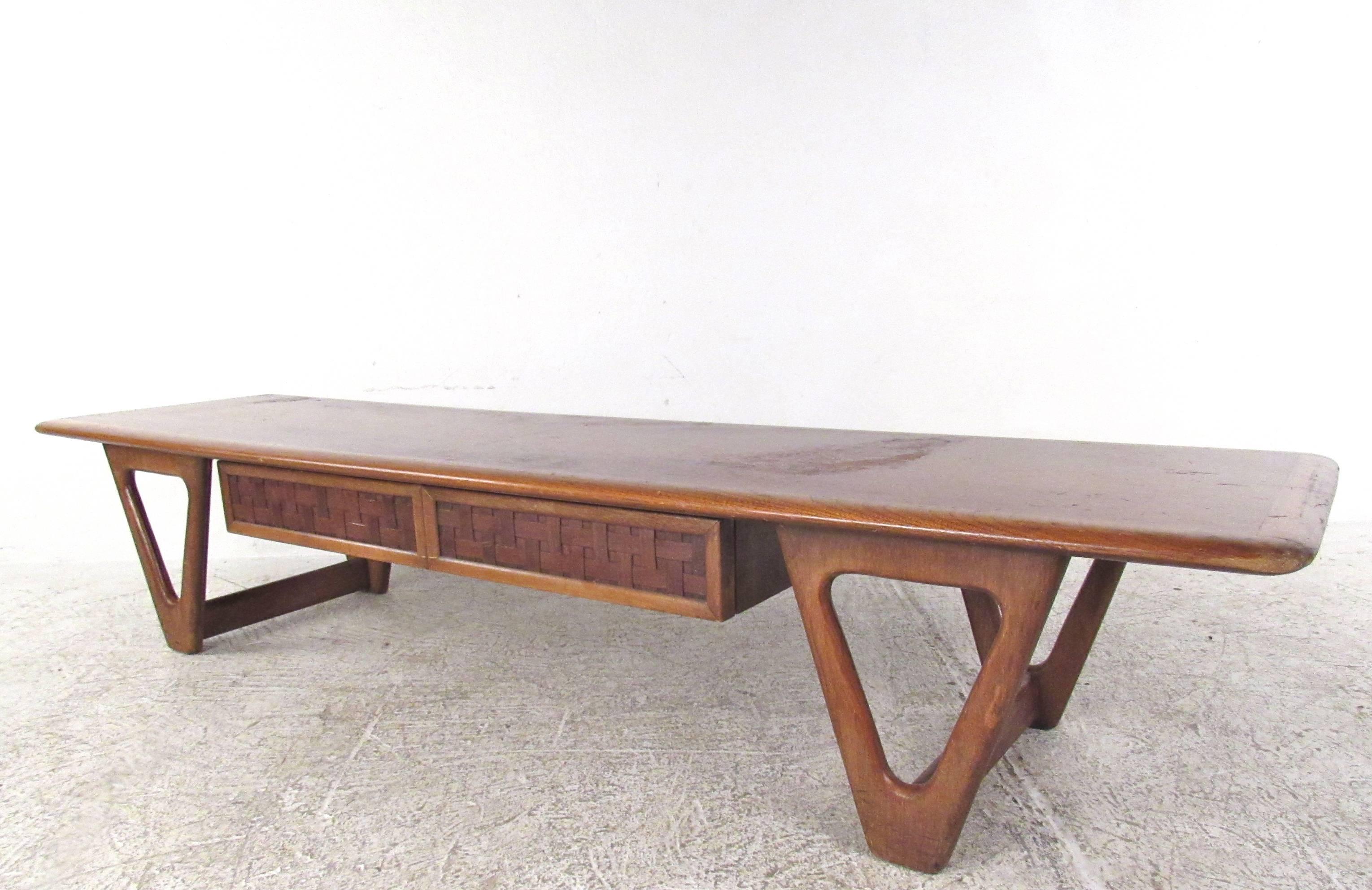 This uniquely sculpted coffee table features a single drawer with basket woven details, as well as a stylish table base. Oak banded top further showcases Warren Church's iconic design prowess. Please confirm item location (NY or NJ).