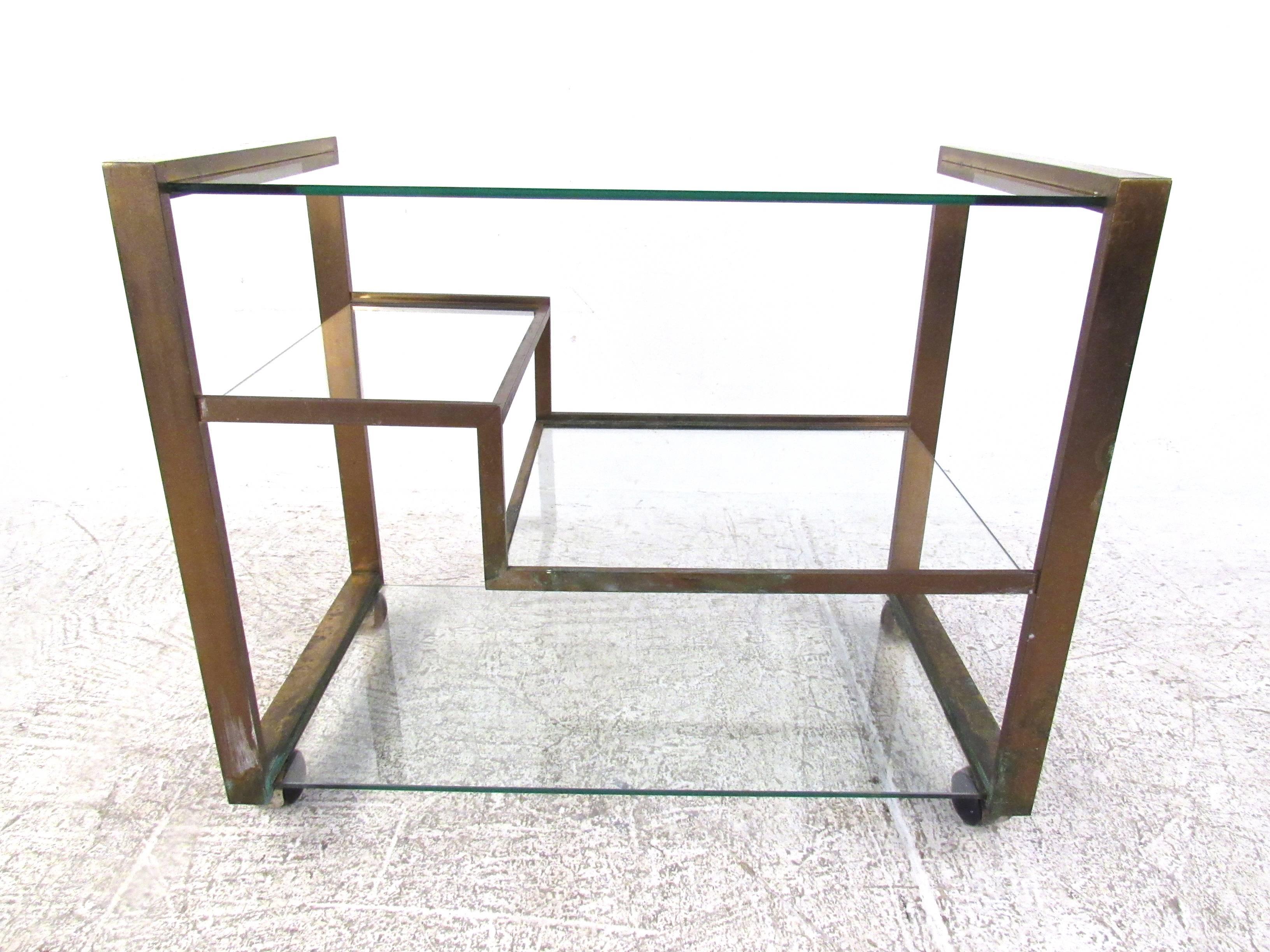This vintage brass serving cart features unique Mid-Century design, combining simple lines and plenty of room for storage or service. Made in Italy by GI.BI  Please confirm item location (NY or NJ). 