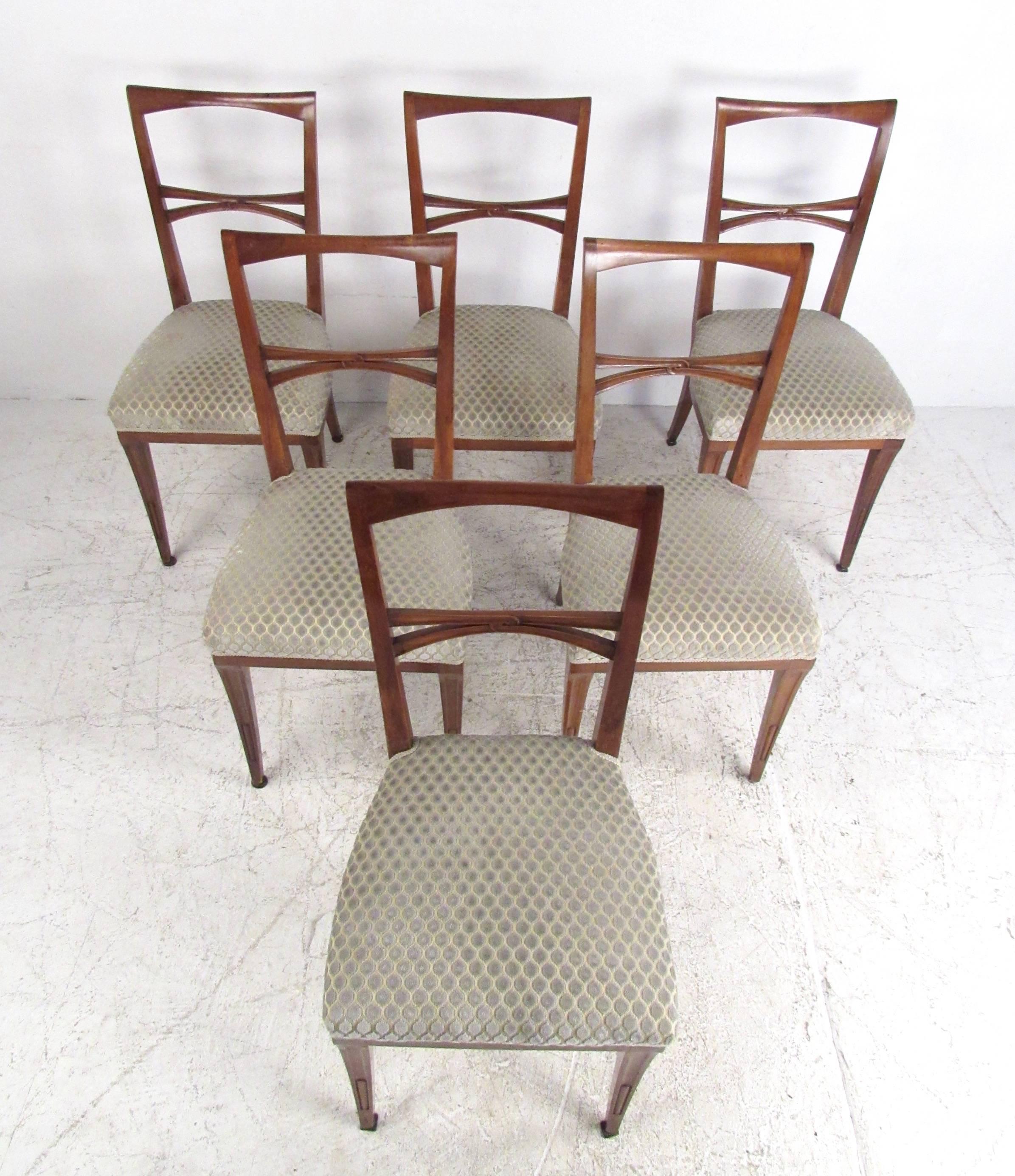 This set of six elegant dining chairs features unique sculpted seat frames, upholstered seats, and uniquely stylized tapered legs. Unique mix of vintage style and comfort, this matching set of Mid-Century Italian dining chairs make an excellent