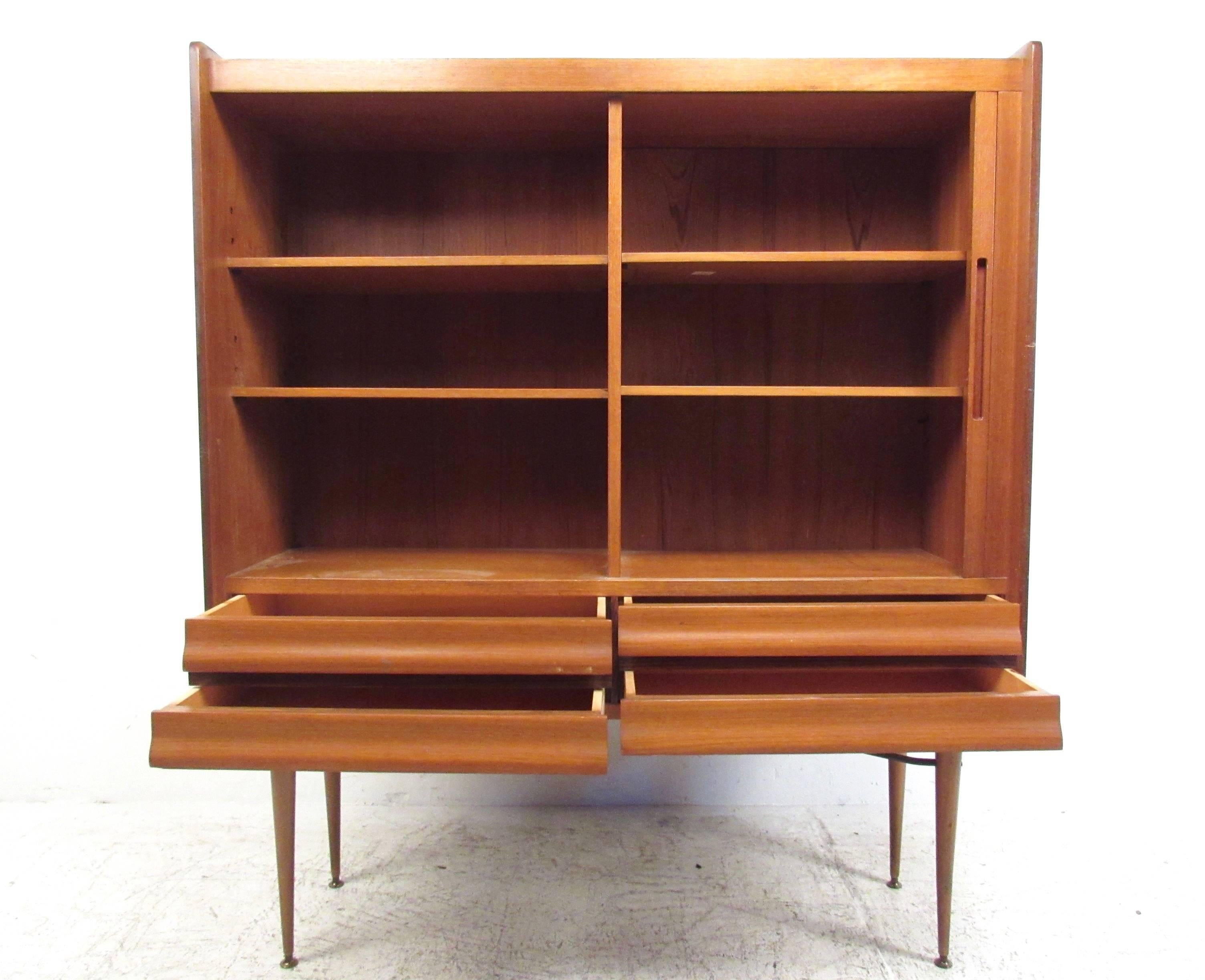 This tall vintage cabinet features unique Scandinavian style with plenty of storage in side-by-side arrangement. Mixed wood design combines mahogany, teak, and rosewood for a beautiful end product. Open shelves for display are paired with a stylish