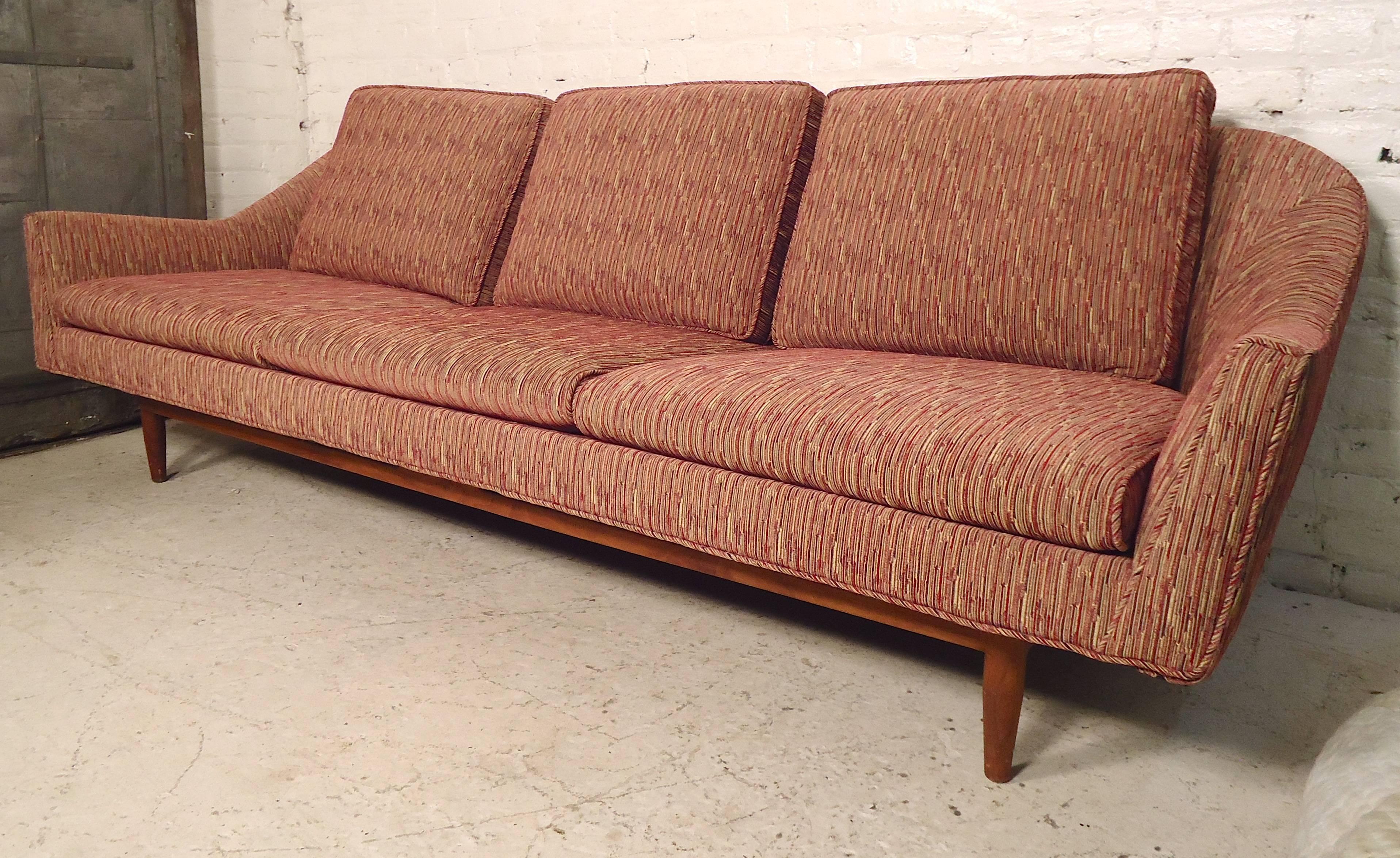 Beautiful curved back three-seat sofa by Jens Risom. Simple and elegant lines that feature a curved back, sculpted wood base and funky patterned upholstery.

(Please confirm item location NY or NJ with dealer).
                     