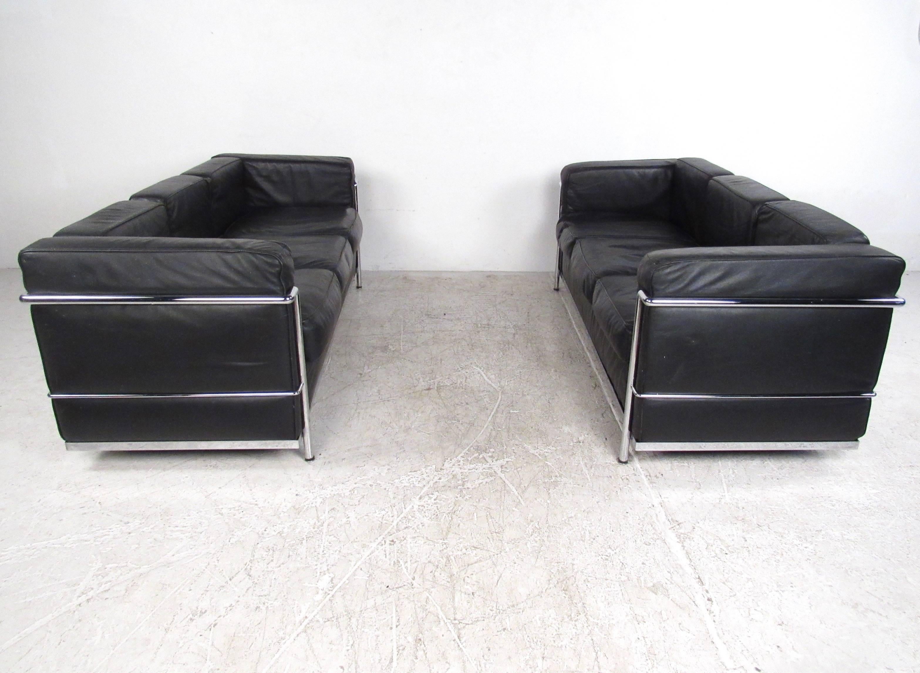 This matching pair of vintage leather sofa's features the stylish chrome frame and overstuffed construction made famous by Le Corbusier, Pierre Jeanneret and Charlotte Perriand in their work for Cassina. Fantastic mix of comfort and modern elegance.