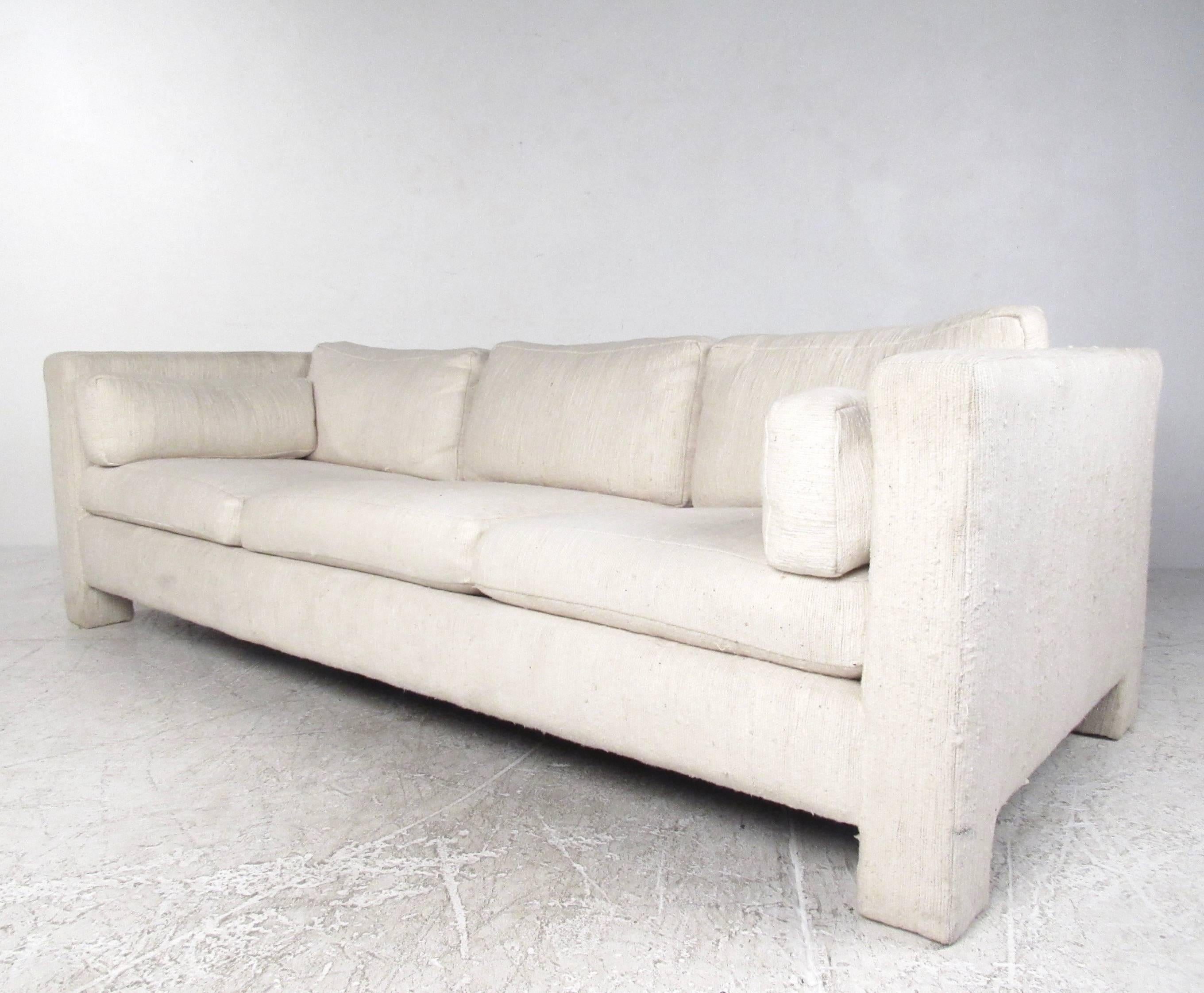 This comfortable modern sofa features the Mid-Century design of Milo Baughman as manufactured for Thayer Coggin. Subtle lines and comfortable proportions make this vintage sofa an excellent addition to any seating arrangement. Please confirm item