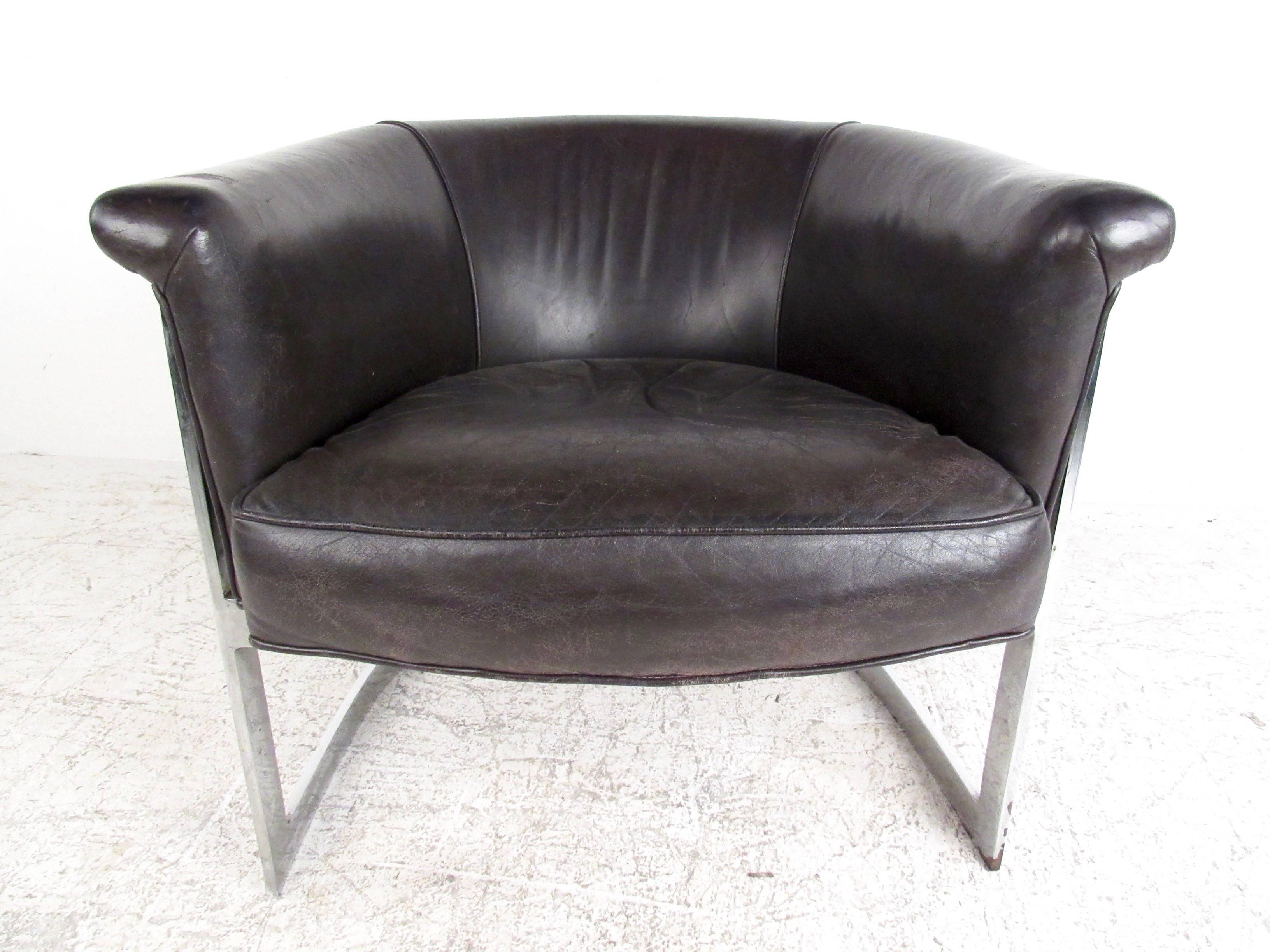 This unique barrel back chair features rich dark brown leather with a chrome finish cantilever base in the style of Milo Baughman. Comfortable and stylish Mid-Century seating for any interior, this unique rounded back club chair combines vintage