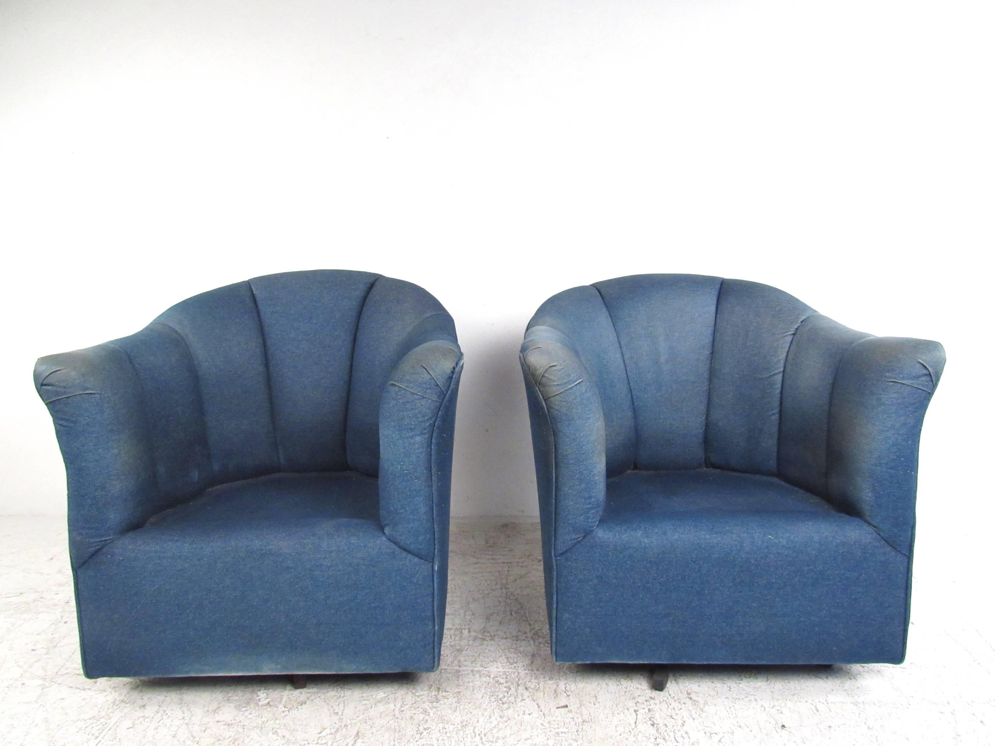 This comfortably upholstered pair of chairs features denim covering, comfortable overstuffed cushioning, and swivel bases. Unique and comfortable pair of chairs suitable for any modern or contemporary setting. Please confirm item location (NY or NJ).