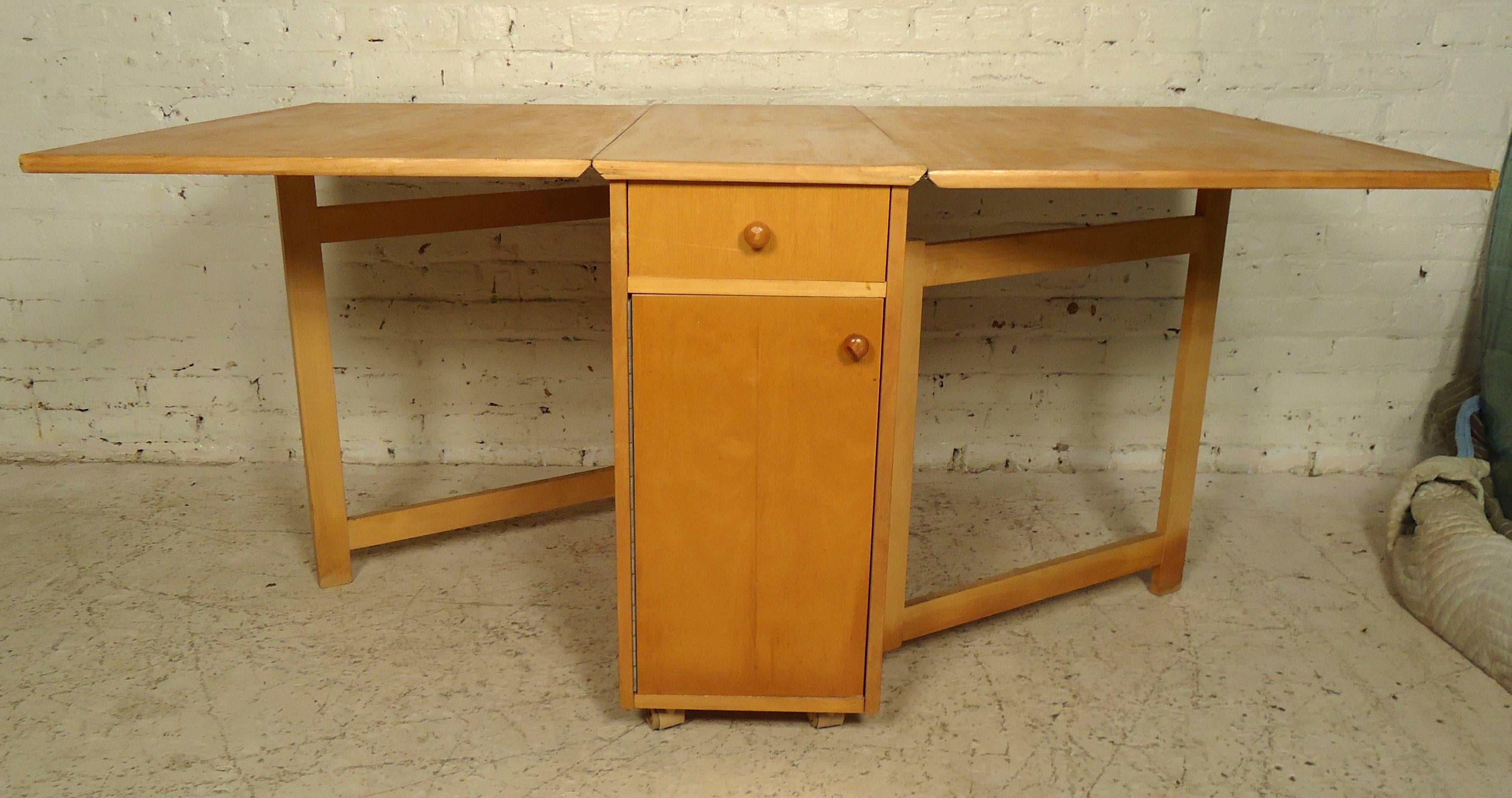 Vintage dining set and four folding chairs. The chairs stow away inside the table perfectly. Table also features one-drawer and is on four wheels that make it easy to maneuver.
Opens to 60" wide.

(Please confirm item location - NY or NJ -
