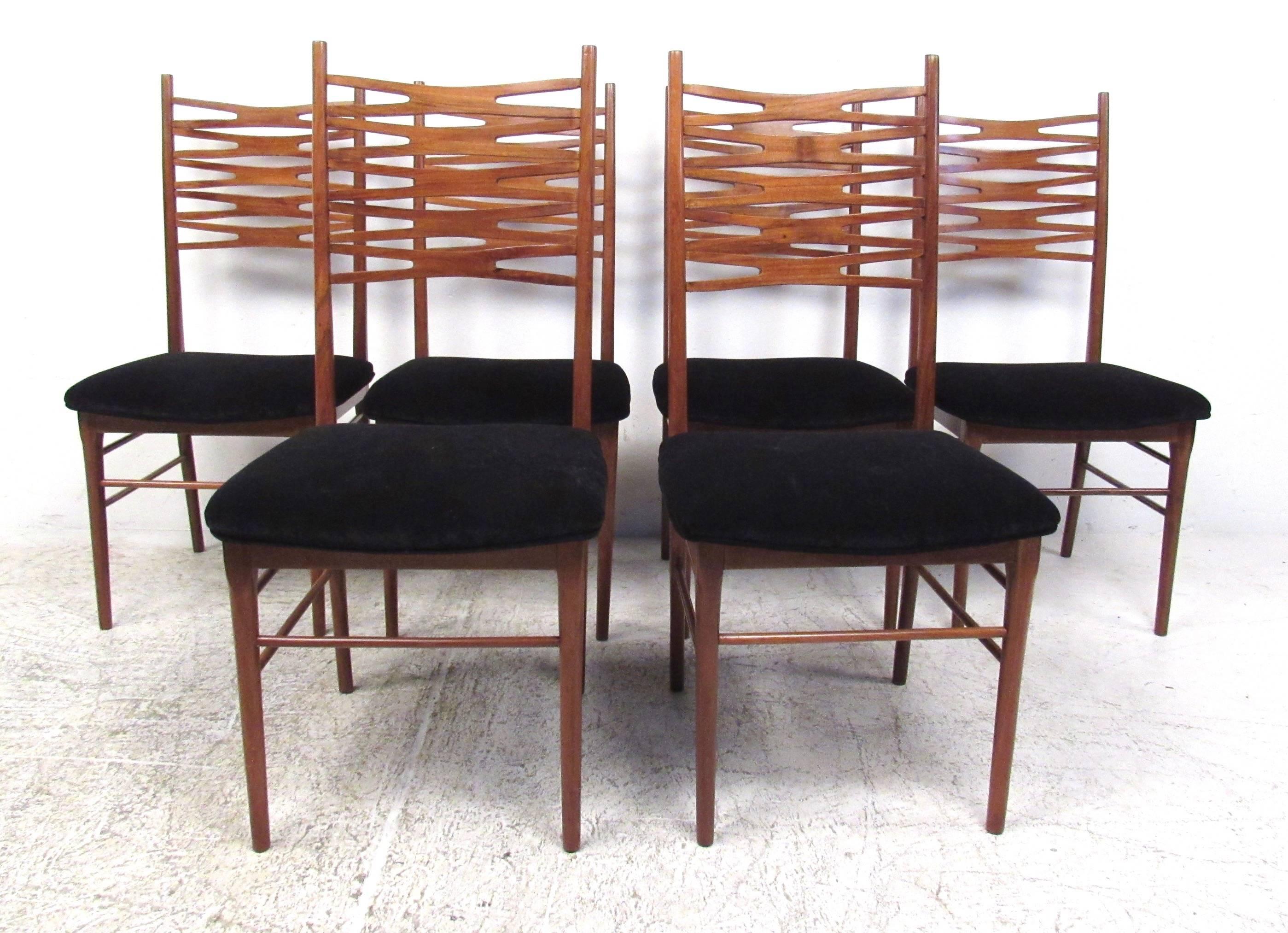 This beautiful set of carefully sculpted teak dining chairs features uniquely carved X-style seat backs, tapered legs and four-way stretchers for added support. Comfortable upholstered seats make these the perfect mix of style and comfort, and the