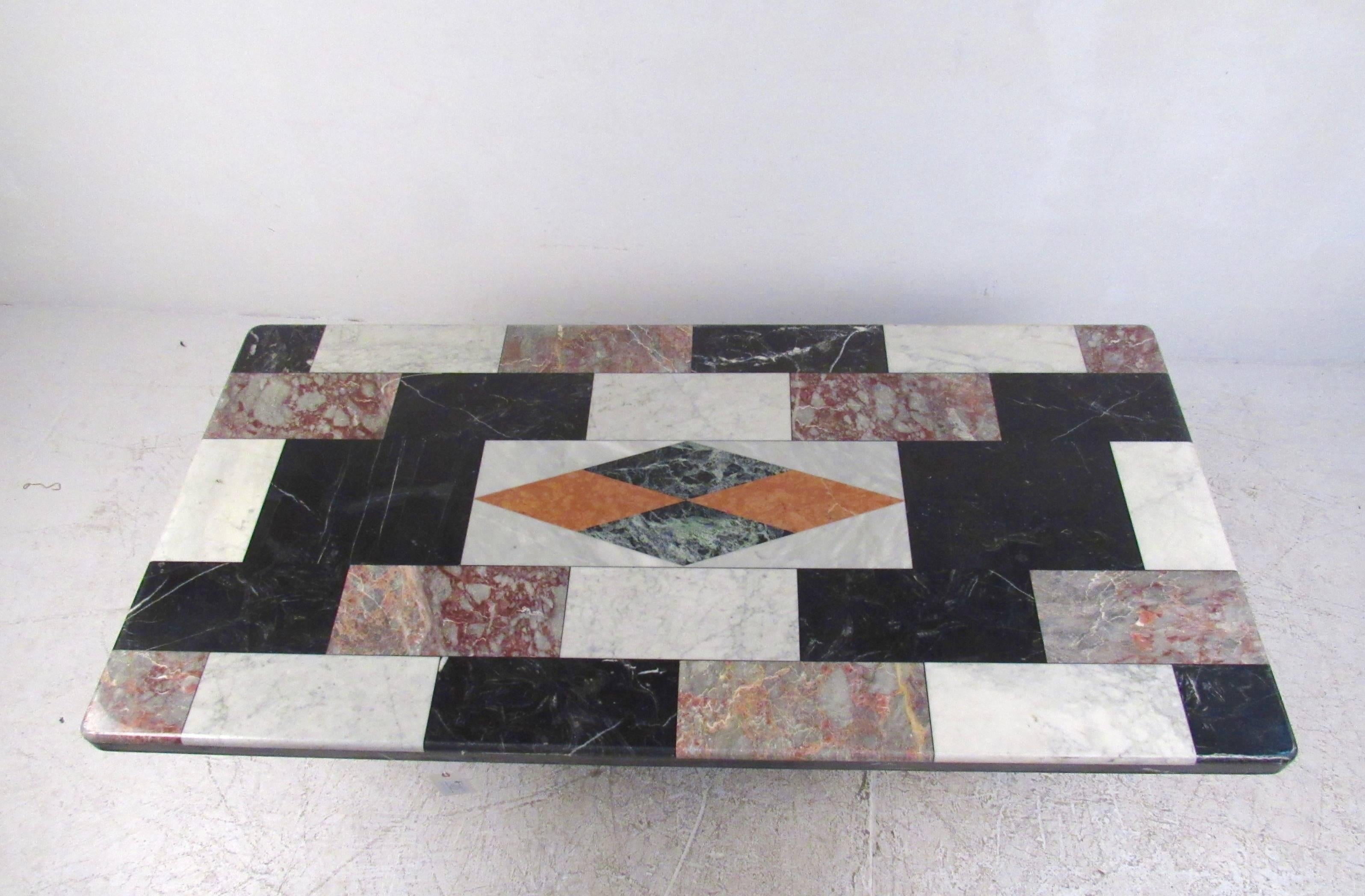This stunning vintage Italian marble-top table features unique mixed marble top with decorative geometric inlay. Sturdy pedestal design allows for plenty of leg room underneath, while the unique multicolored top adds impressive Mid-Century style to