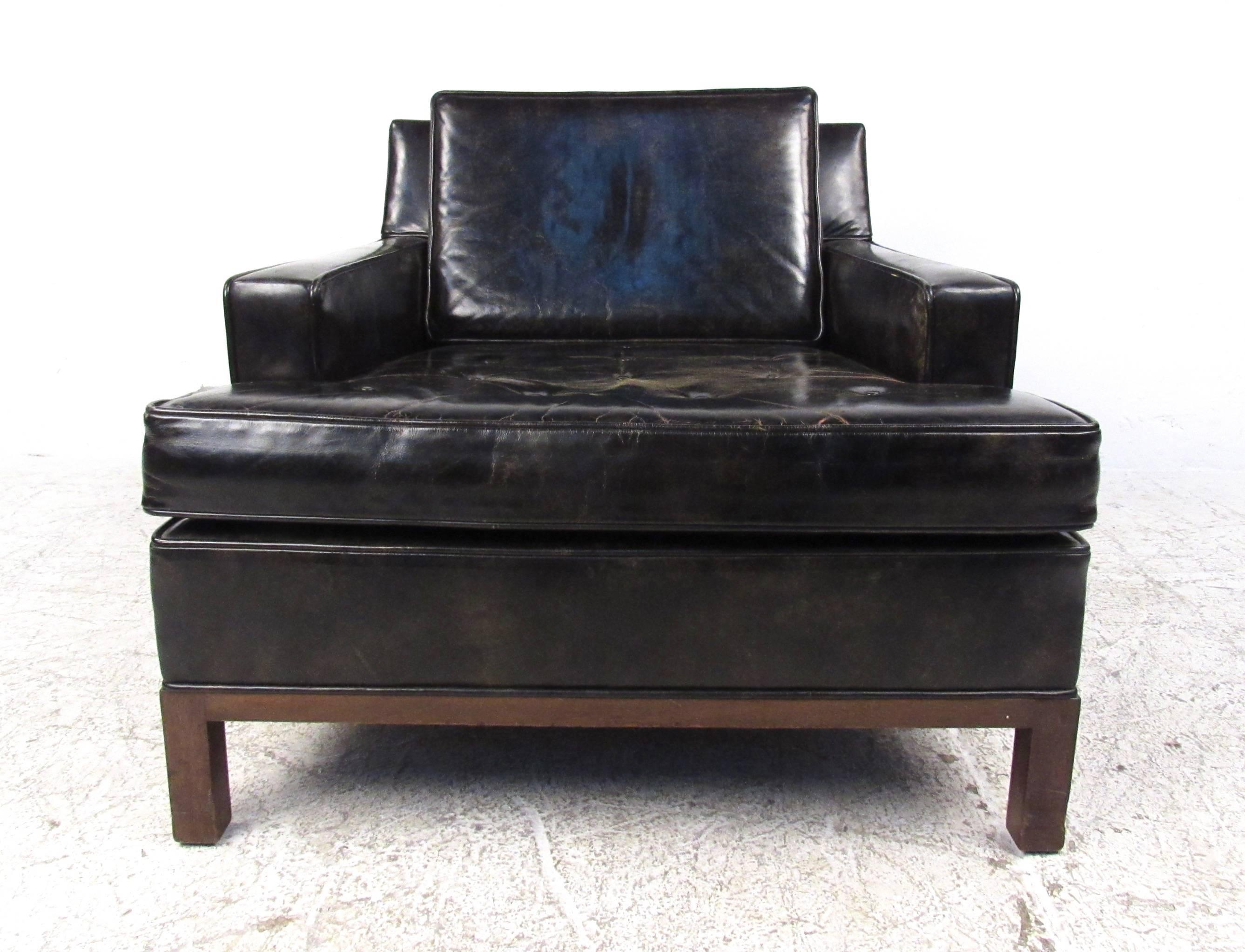 This comfortable vintage leather lounge chair by Harvey Probber features rich leather upholstery, a wonderful patinated look, and comfortable proportions. Walnut trim and legs add to the unique mid-century appeal of the piece, the original