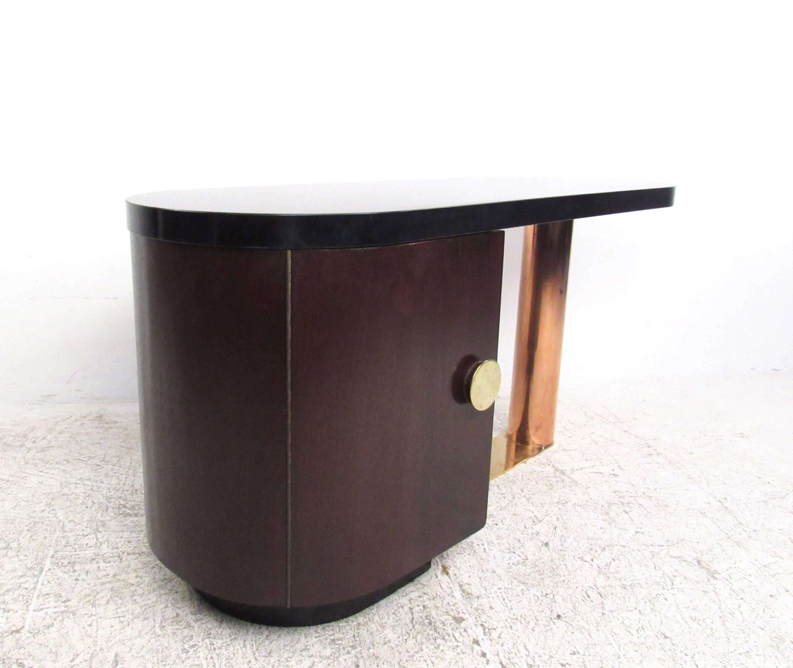 This unique vintage desk features dual pedestal construction in a lovely mixture of copper, brass, and wood construction. Storage cabinet offers added drawers for convenient storage, while unique door pull accents the Mid-Century Modern charm of the