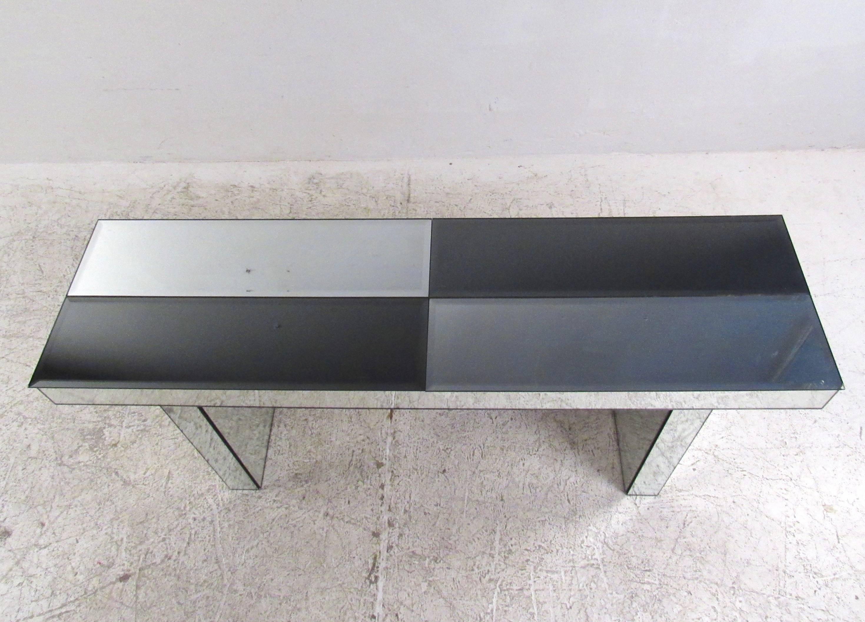 This unique vintage console table features two-tone beveled glass top and mirrored pedestal base. Perfect table for entryway, hall, or office display. Please confirm item location (NY or NJ.)
