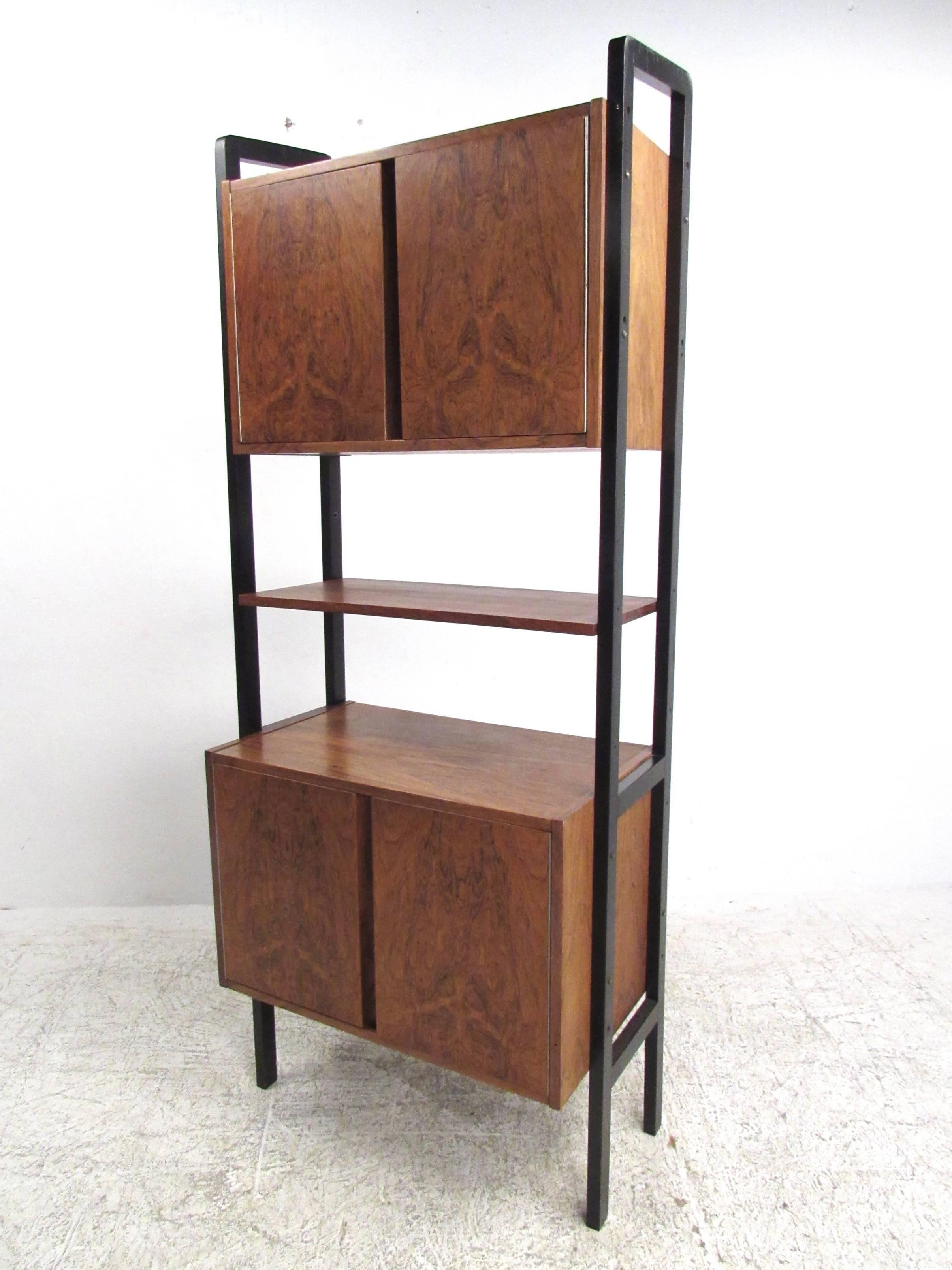 This dual cabinet rosewood wall unit features modular construction that offers storage and display options perfect for home or office. Versatile storage with classic Mid-Century style! Please confirm item location (NY or NJ).