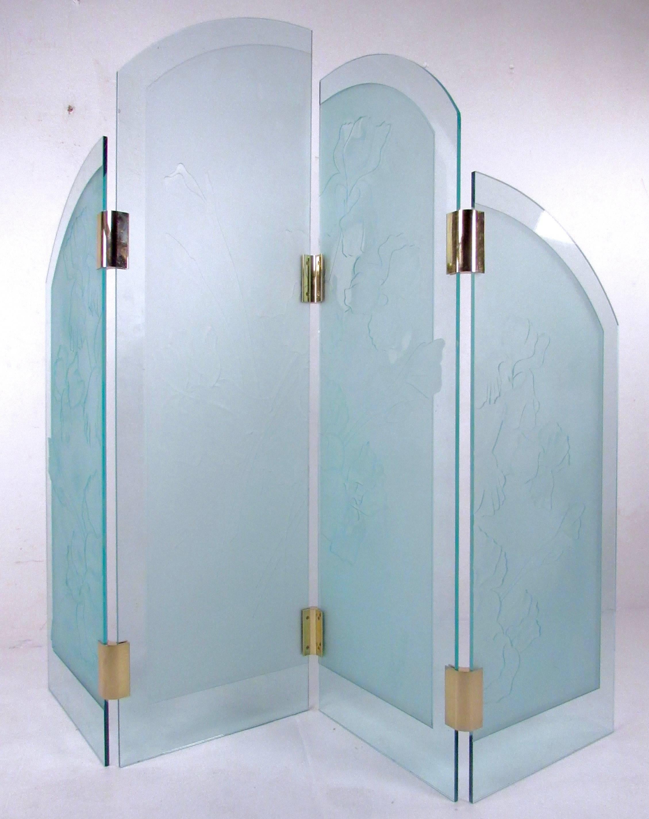 This unique four-panel etched glass room divider features opaque tinted glass with etched floral designs. Brass finish joints secure the staggered height panels, creating an impressive semi-transparent screen for a variety of applications in home,