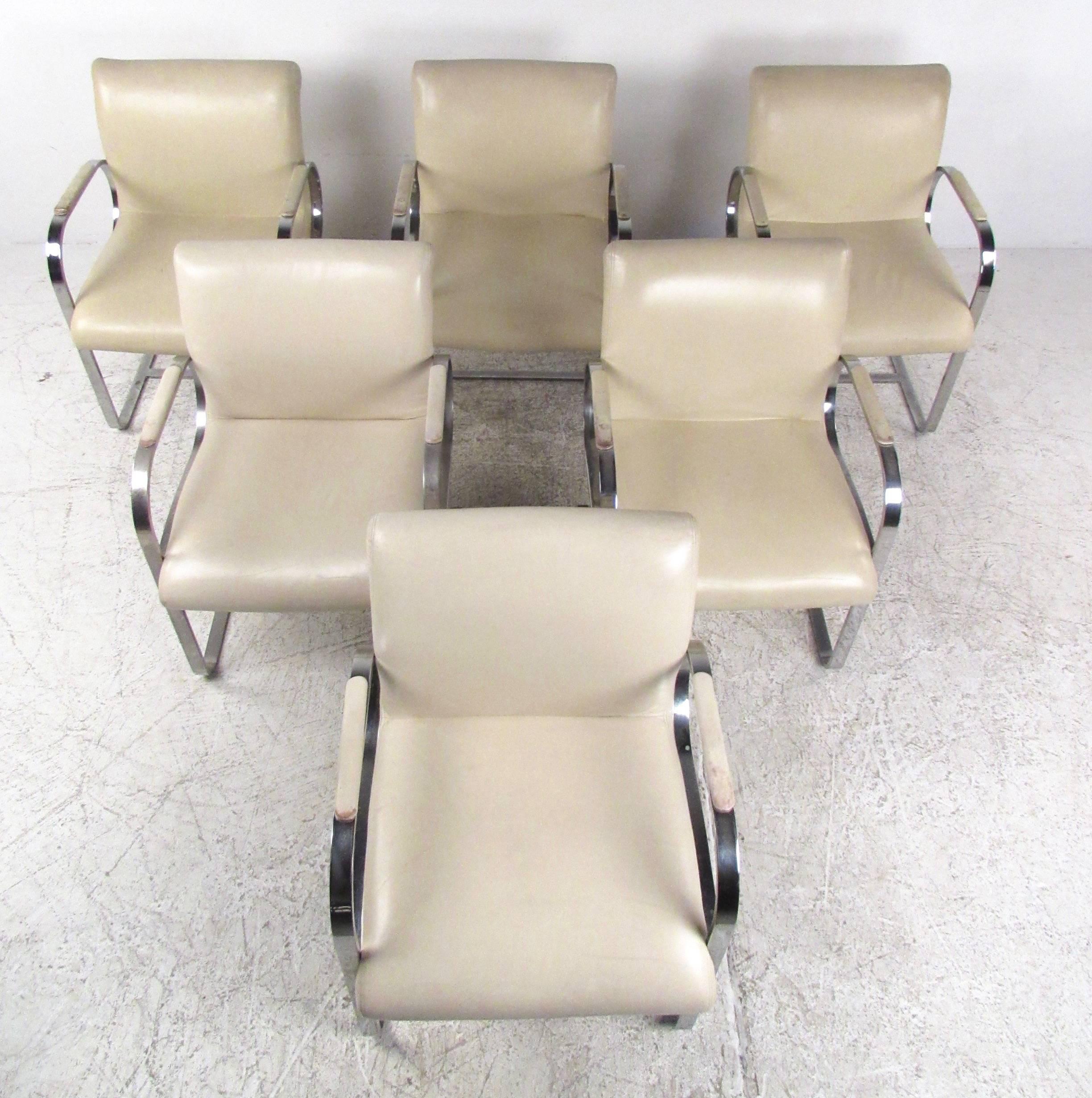 This high quality set of vintage leather and chrome dining chairs features very heavy chrome construction and stylish cantilever design. The matching set boasts an impressive design similar to Mies van der Rohe Brno style chairs, but with an even