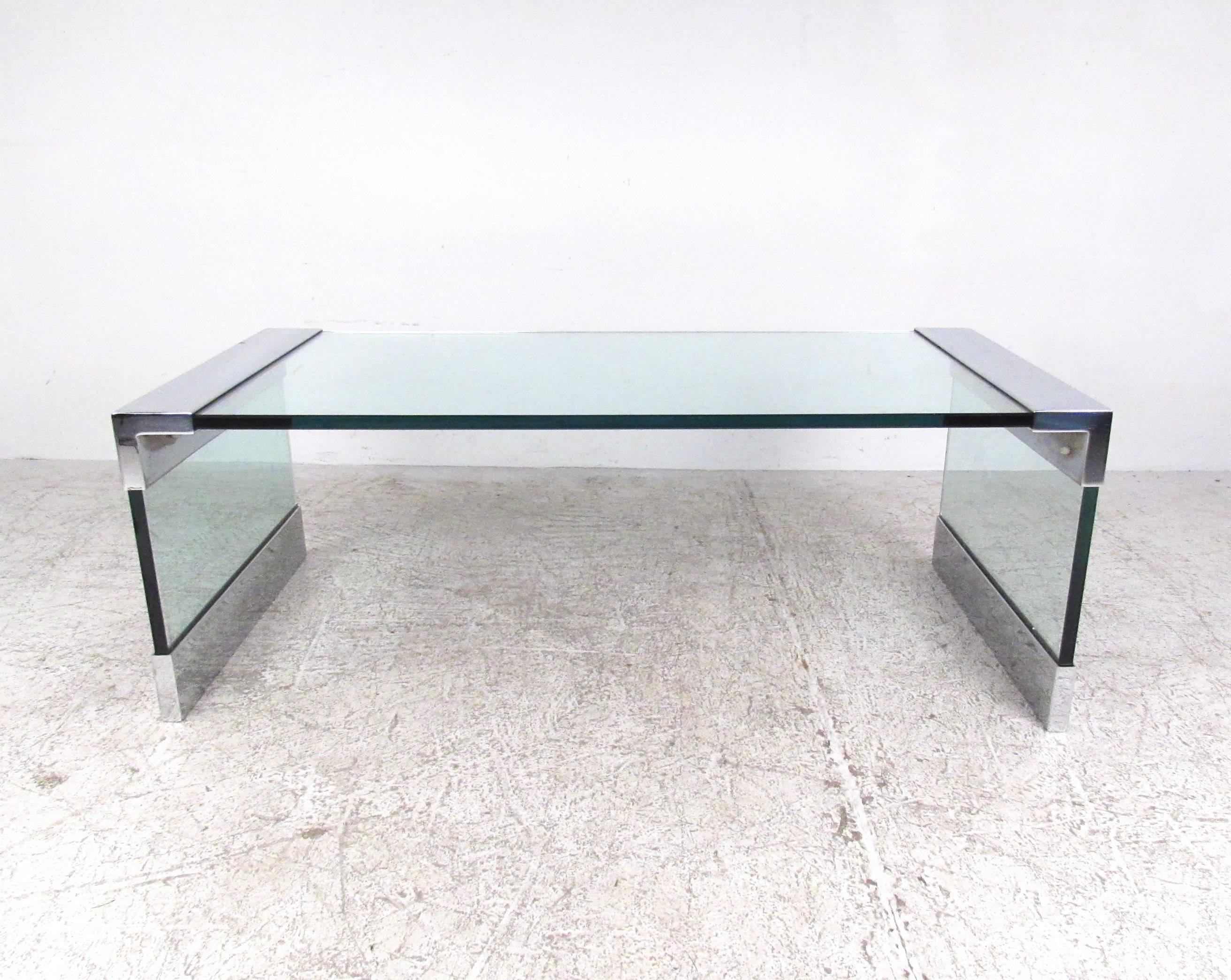 This uniquely angular coffee table features impressive Mid-Century style with quality chrome and glass construction. Thick glass top and sled legs are protected and accented by heavy chrome fittings. Similar in style to the popular Pace designed