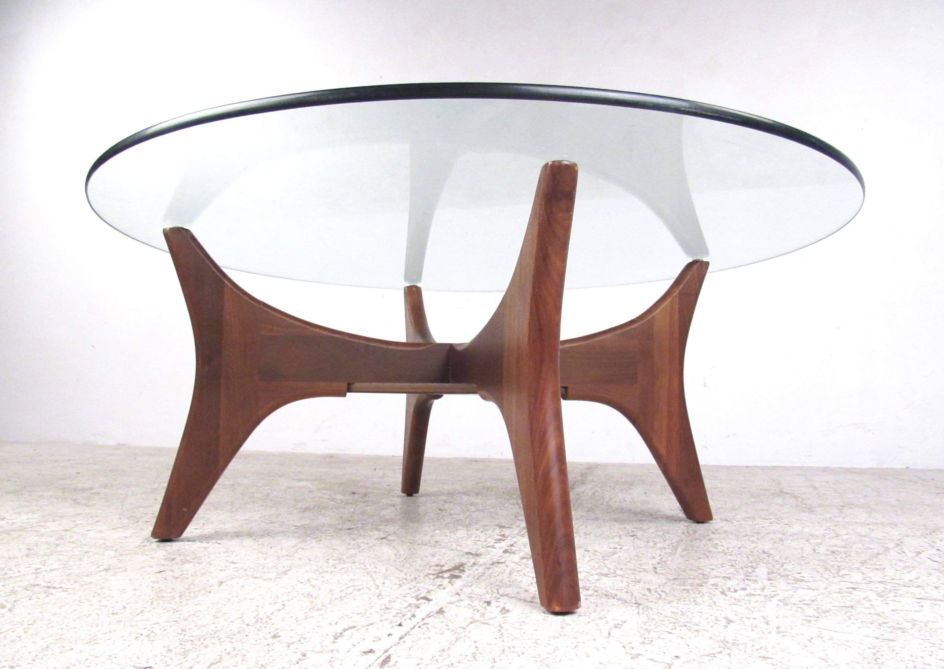 This uniquely designed Mid-Century coffee table makes a beautiful vintage addition to any interior. The Adrian Pearsall style sculpted walnut base is an elegant example of rustic modern design, the unique shape of the table enhanced by it's natural