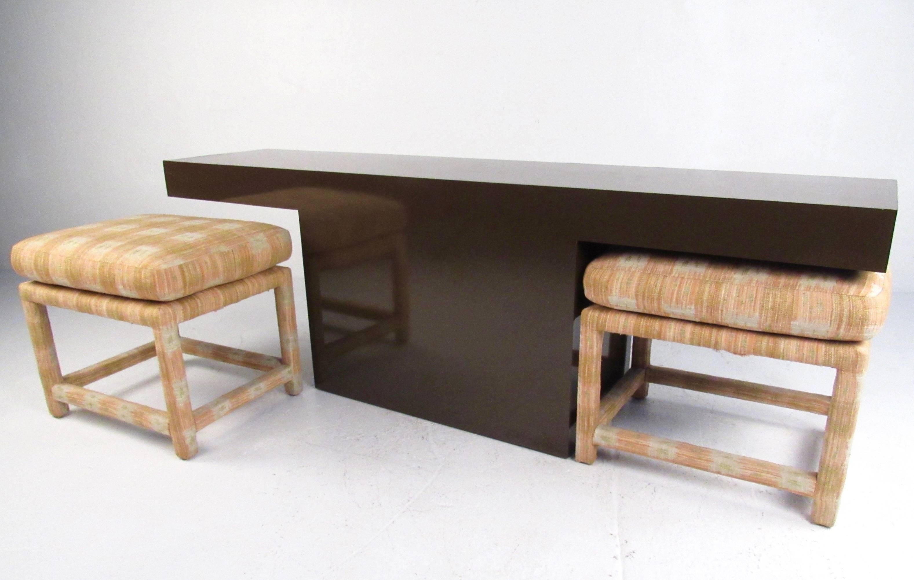 This Mid-Century Modern Milo Baughman console table comes paired with matching parson's style upholstered benches. These stylish four-legged benches feature vintage fabric and unique style, perfectly fitted to the height of the table. This stunning