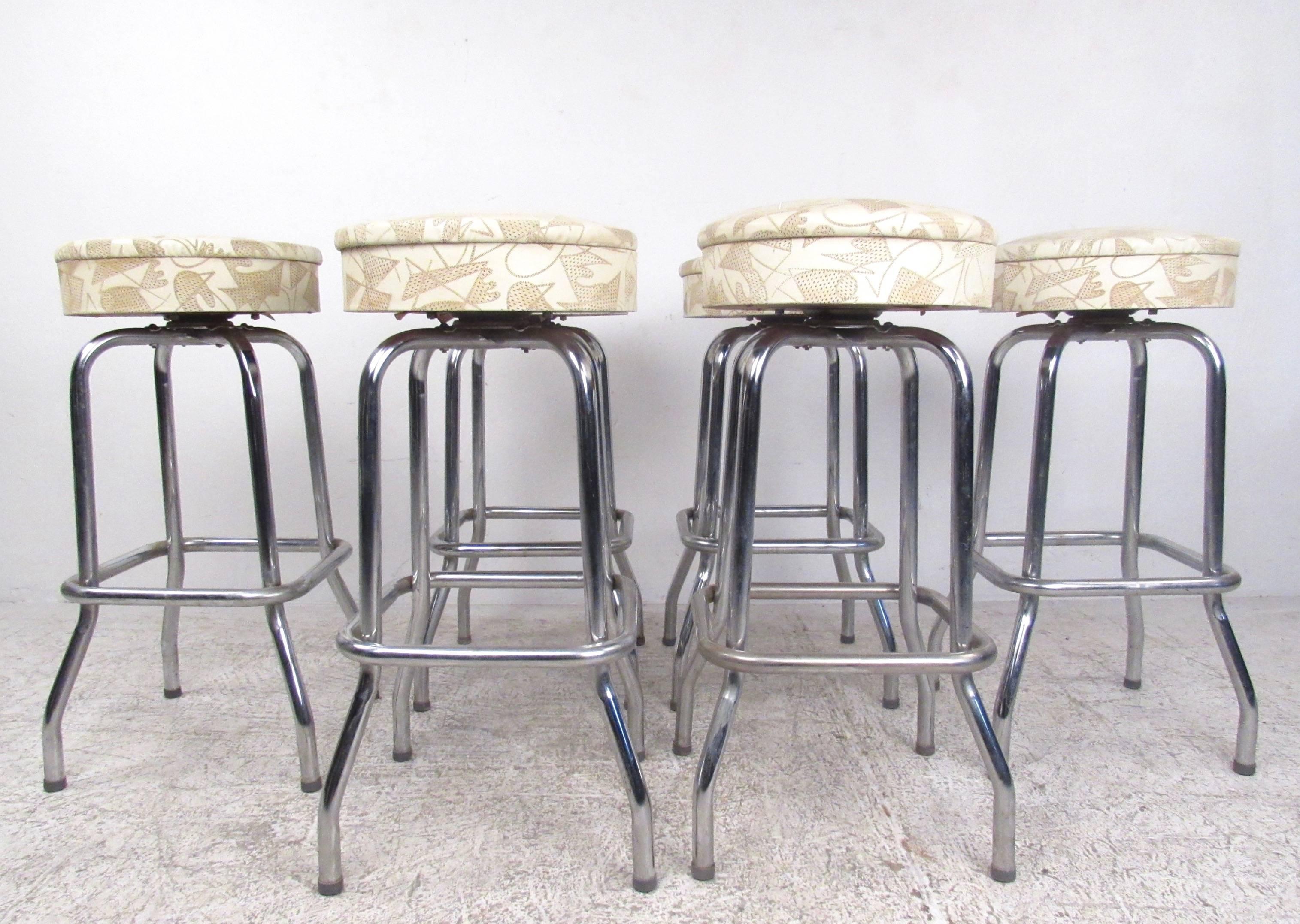 This set of six vintage barstools features bar height chrome constructions with swivel vinyl seats. Textured designs in vinyl add to the Mid-Century style of the set, while flared leg bases with metal stretchers make these substantial and sturdy