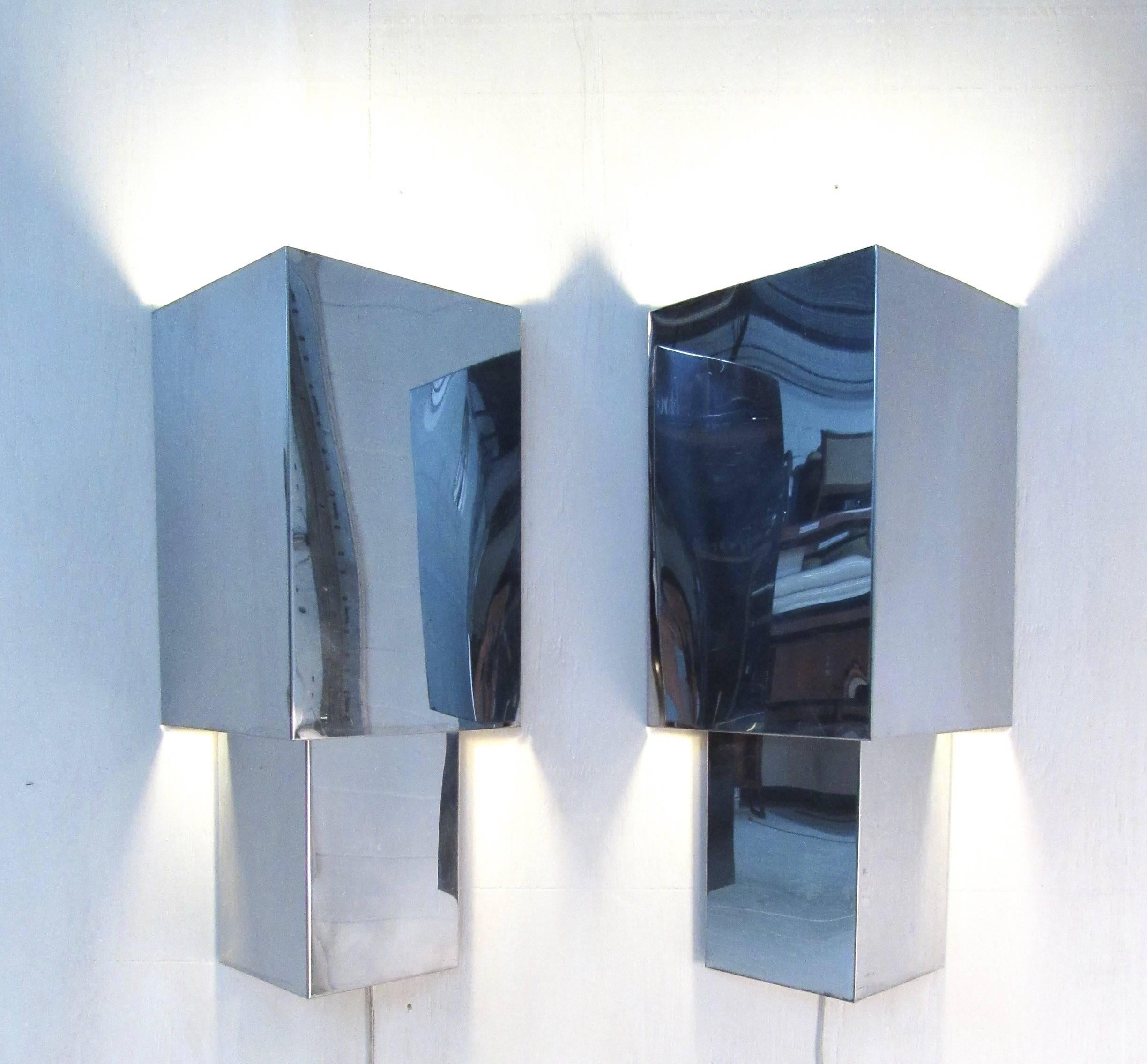 This matching pair of vintage chrome wall sconces features triangular metal construction, with unique wall-mounted design. Wonderful wall lighting for home, business, or office, the Mid-Century Modern style is perfect for a variety of settings.