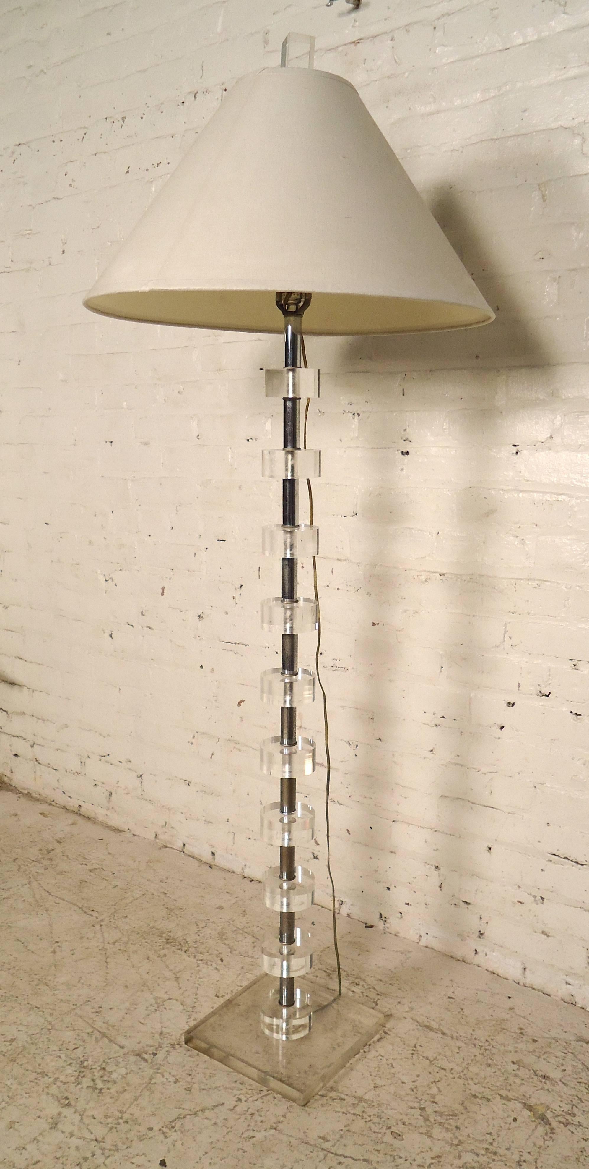 Very unique standing lamp, features Lucite rings held by a long chrome rod, on a sturdy base. 

(Please confirm item location - NY or NJ with dealer).