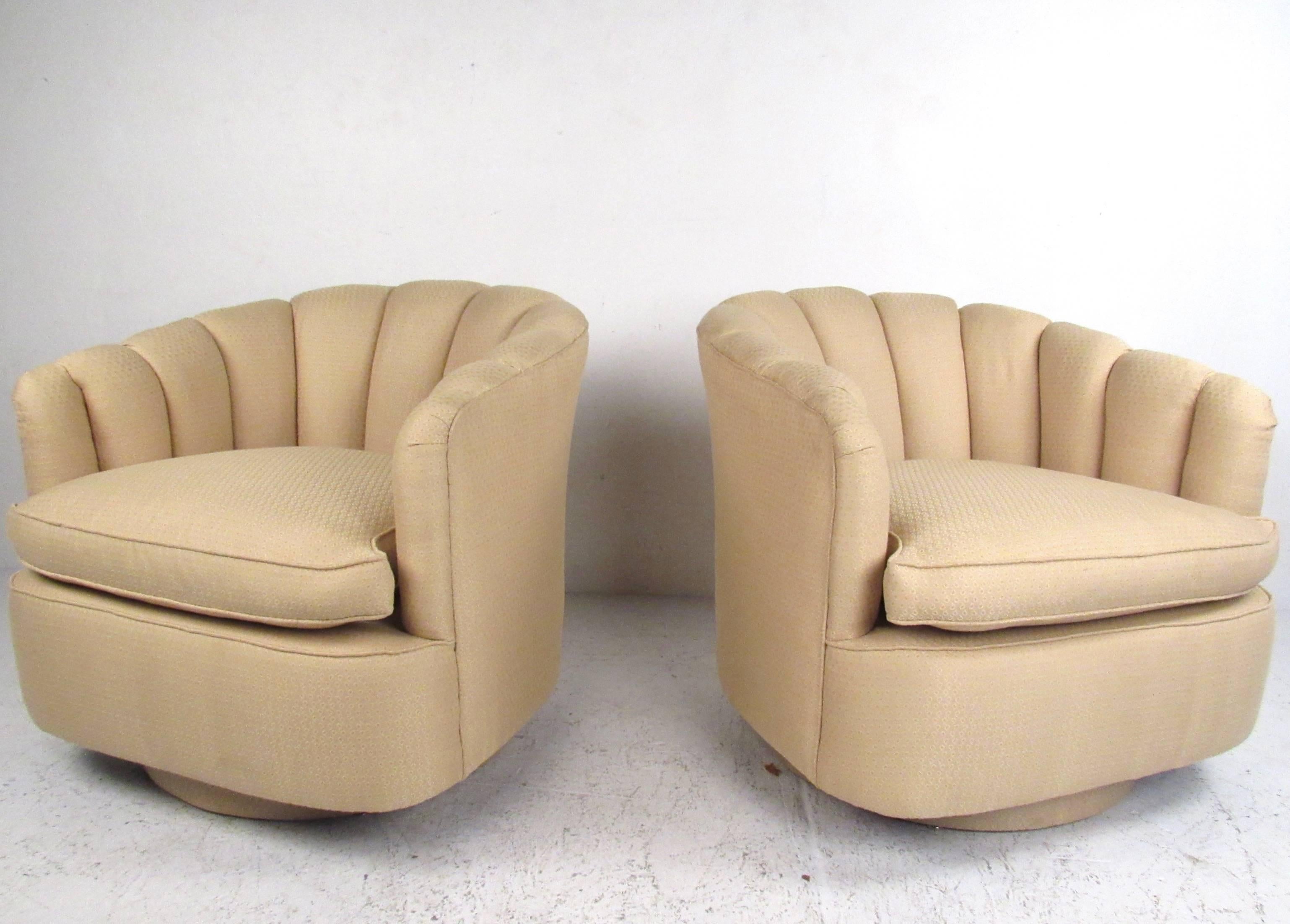 This pair of unique modern lounge chairs make an elegant addition to any living room or office setting. Swivel bases and scalloped rounded seat backs add to the charm of this plush matching pair and also adds a Mid-Century feel in the style of Milo