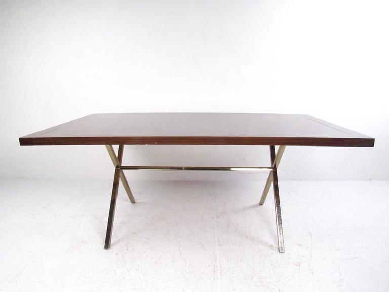 This beautiful vintage dining table features a rich wood veneer with a substantial (heavy) X-style base in the style of Mid-Century master Milo Baughman. This versatile table is elegant in it's simplicity and a beautiful addition to any room as a