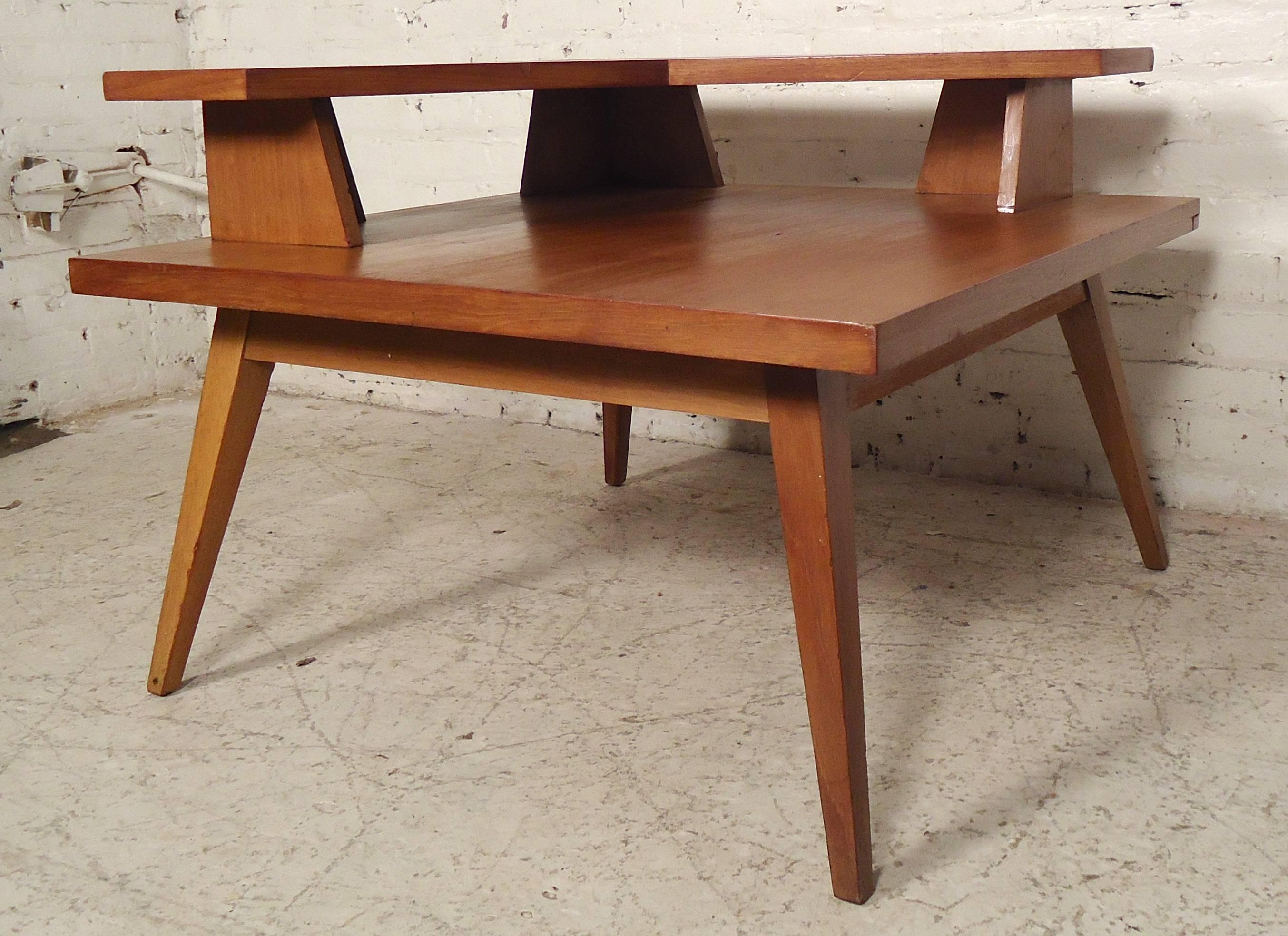 Unique square table with second tier. Angular vintage modern style with tapered splayed legs.

(Please confirm item location - NY or NJ - with dealer).
     