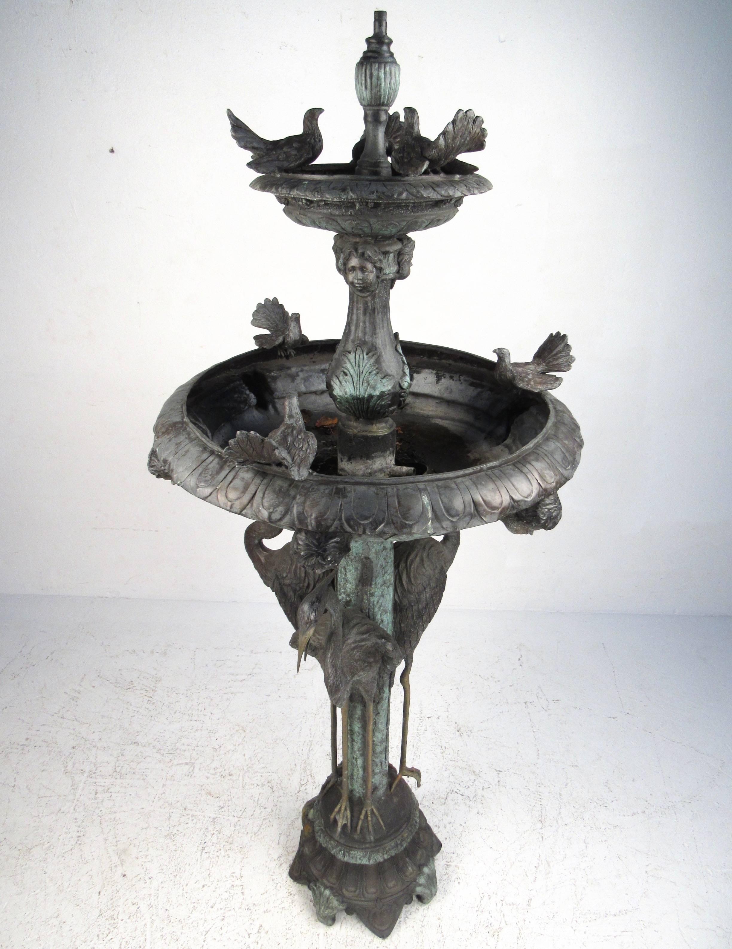 This exquisite bronze garden fountain features wonderful detail throughout it's dual basin cascading water feature design. Bird bath, egrets, and cherub face details add to the impressive stature of this well patinated piece. Please confirm item