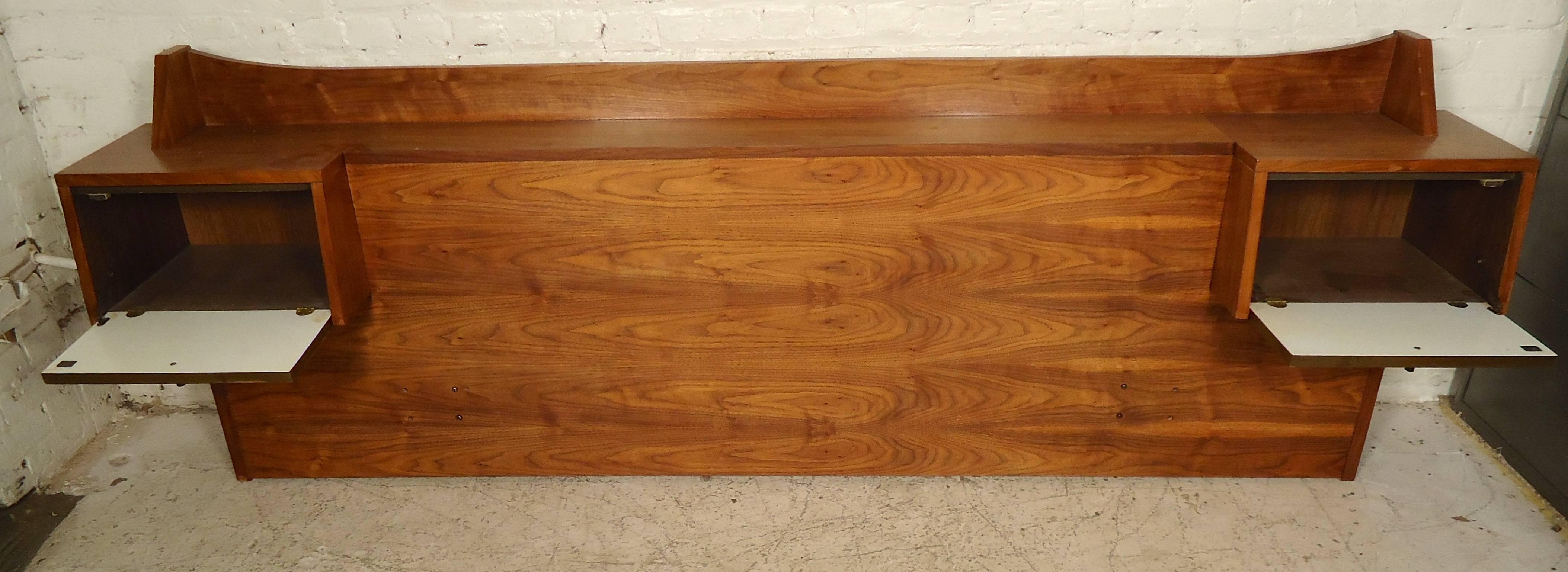 This vintage-modern headboard is uniquely wide, features two side compartments for storage, back shelf and can fit a queen size mattress. It is made from walnut and has been refinished to expose the flow of its walnut grain waves.
Width between