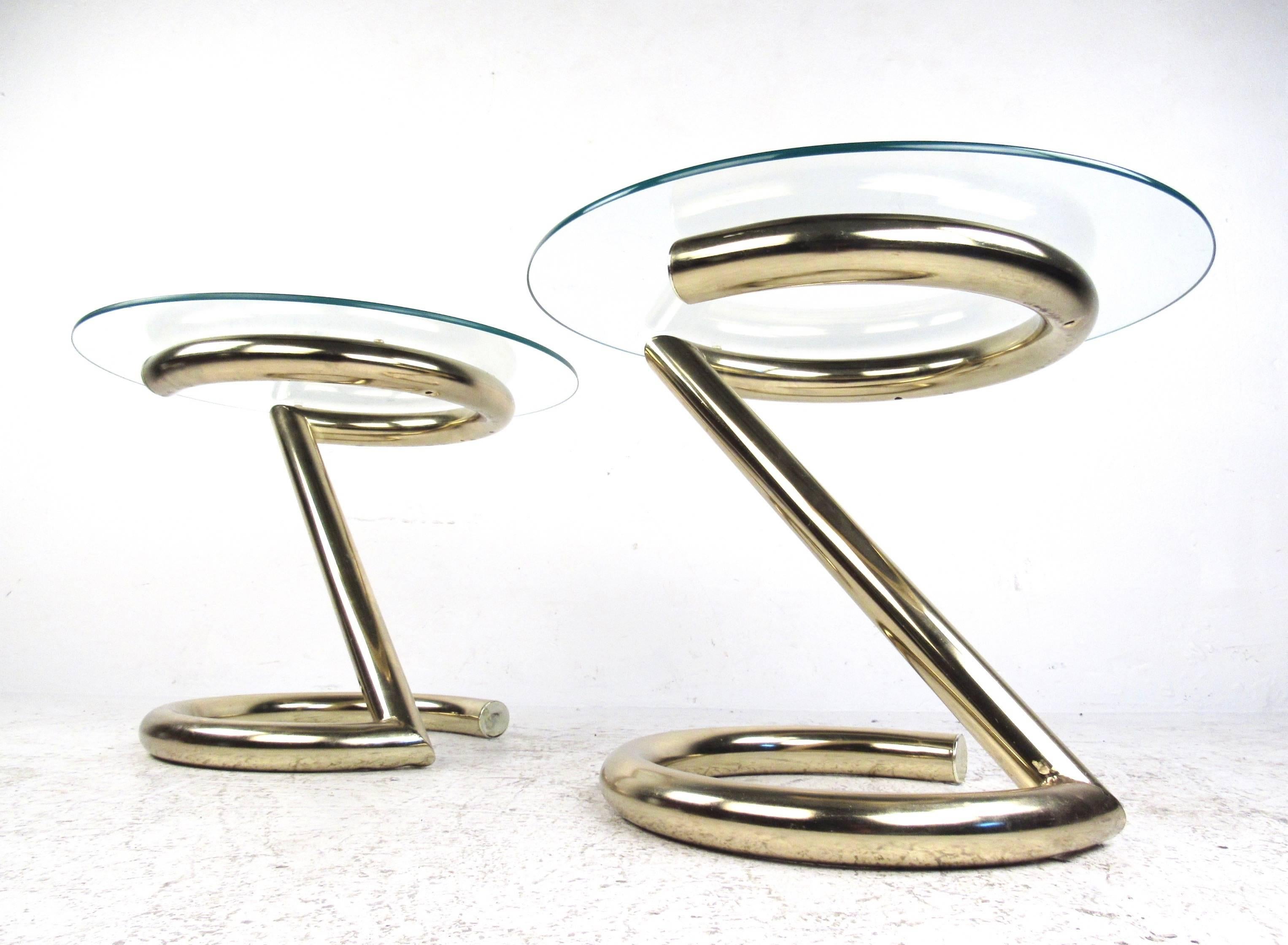 This stylish pair of mid-century modern brass and glass end tables feature unique cantilever bases with brass plated tubular chrome. The vintage matching pair make an excellent addition to any seating area, the perfect modern end tables regardless