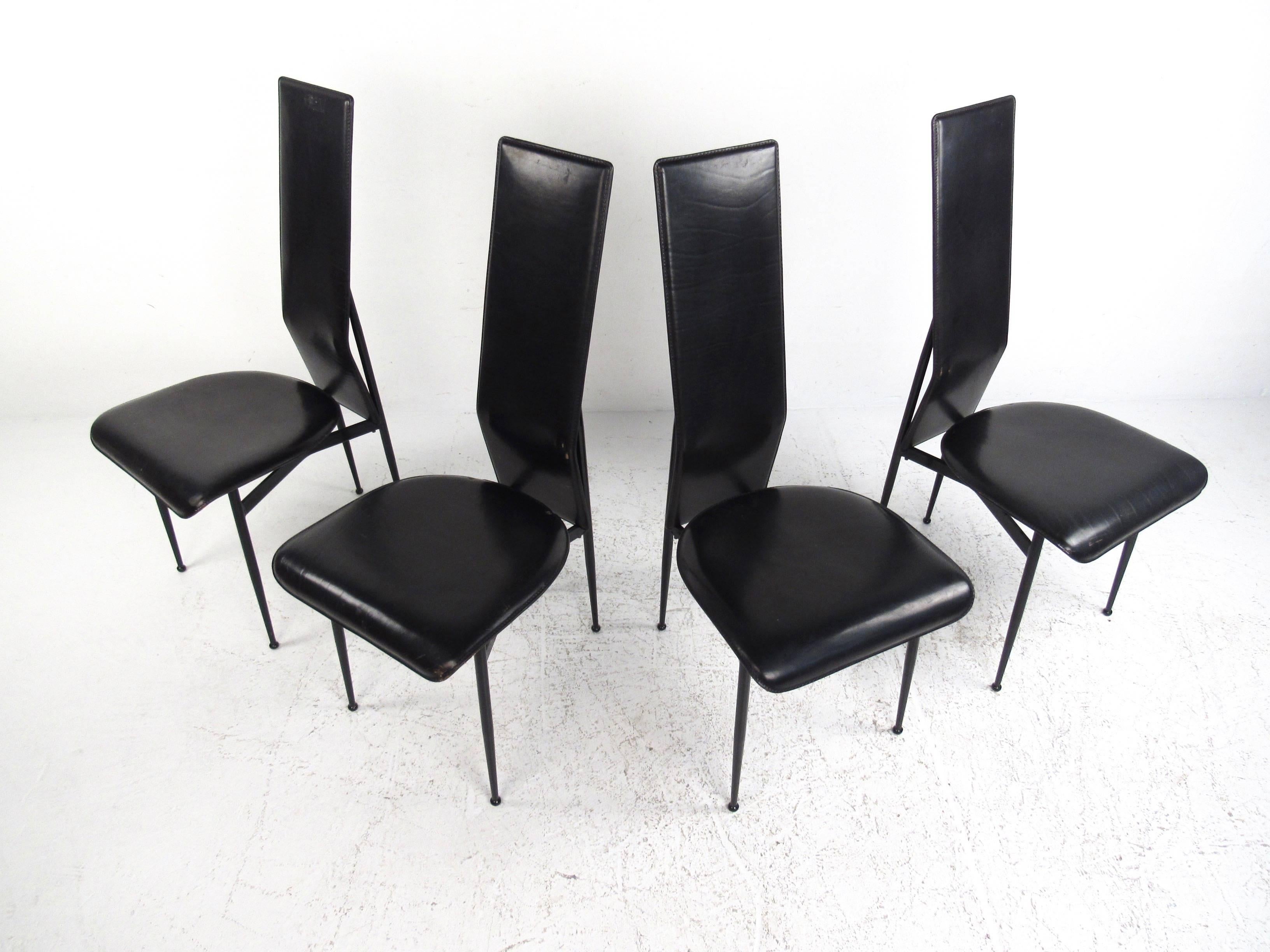 This set of four stylish Italian leather chairs feature exquisite modern design with slender high back seats, tapered legs with drumstick feet, and unique floating ergonomic seats. Wonderful mix of elegant vintage style and timeless comfort by