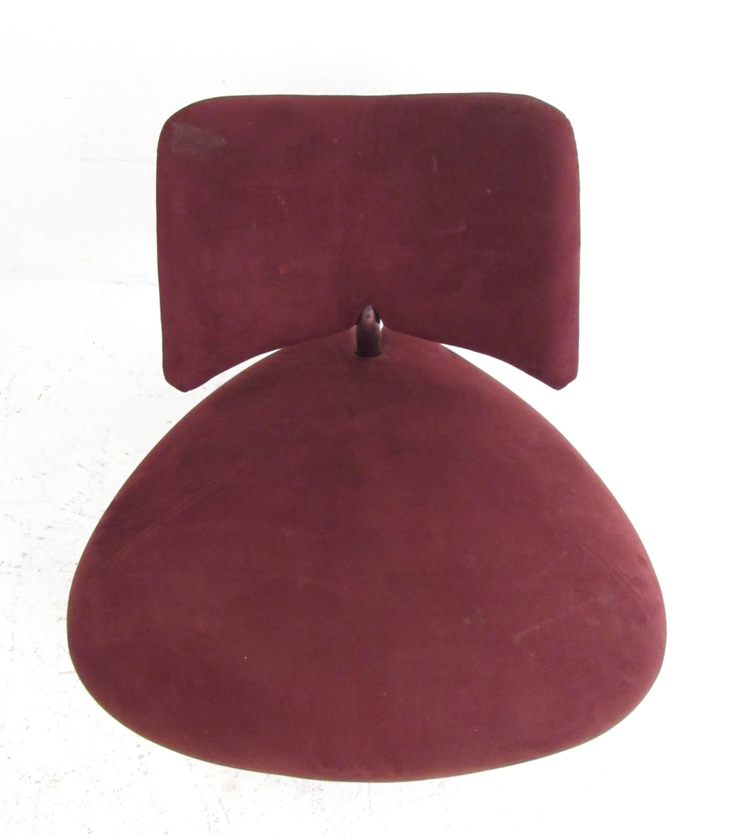 This unique modern slipper chair features maroon suede covering with a unique sculpted seat and seat back. The perfect mix of modern style and incredible comfort, this Roy de Scheemaker design for Leolux (c. 1989) makes a fantastic visual impression