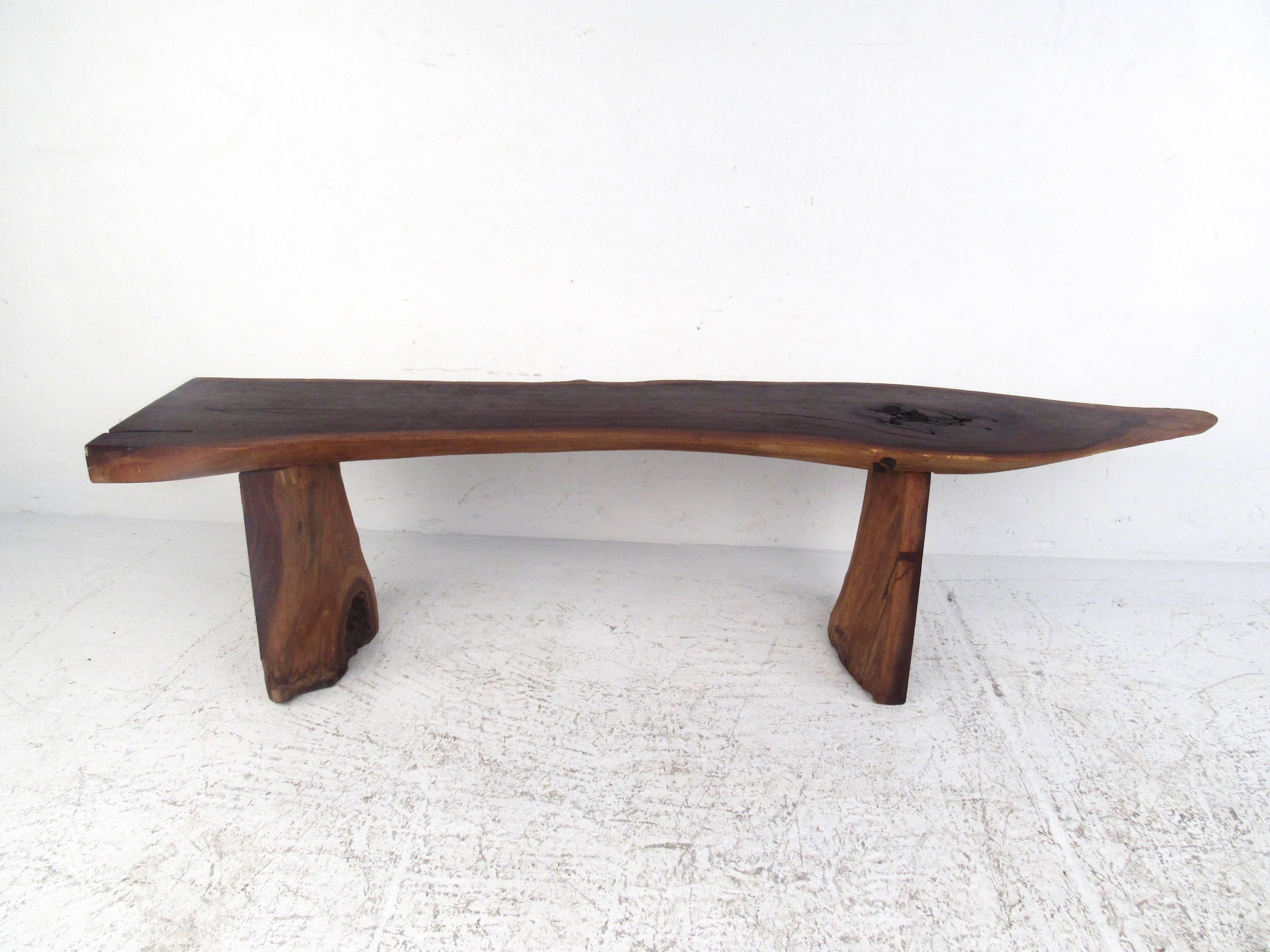 This Mid-Century Modern free edge coffee table features large slab sled legs and a unique free-form top. Impressive natural beauty mixes with vintage rustic design in the style of Phillip Lloyd Powell. Please confirm item location (NY or NJ.)