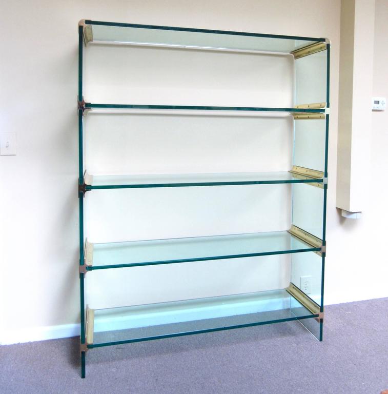 This stunning large-scale display shelf is constructed entirely from Mid-Century brass fixtures and thick green glass. A beautiful etagere for home or shop display, this pace collection style shelf unit makes an impressive addition to any modern