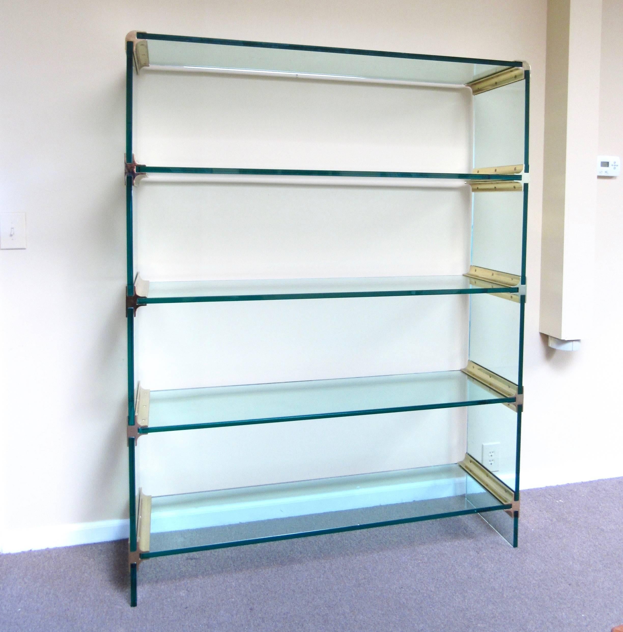 This stunning large-scale display shelf is constructed entirely from Mid-Century brass fixtures and thick green glass. A beautiful etagere for home or shop display, this pace collection style shelf unit makes an impressive addition to any modern