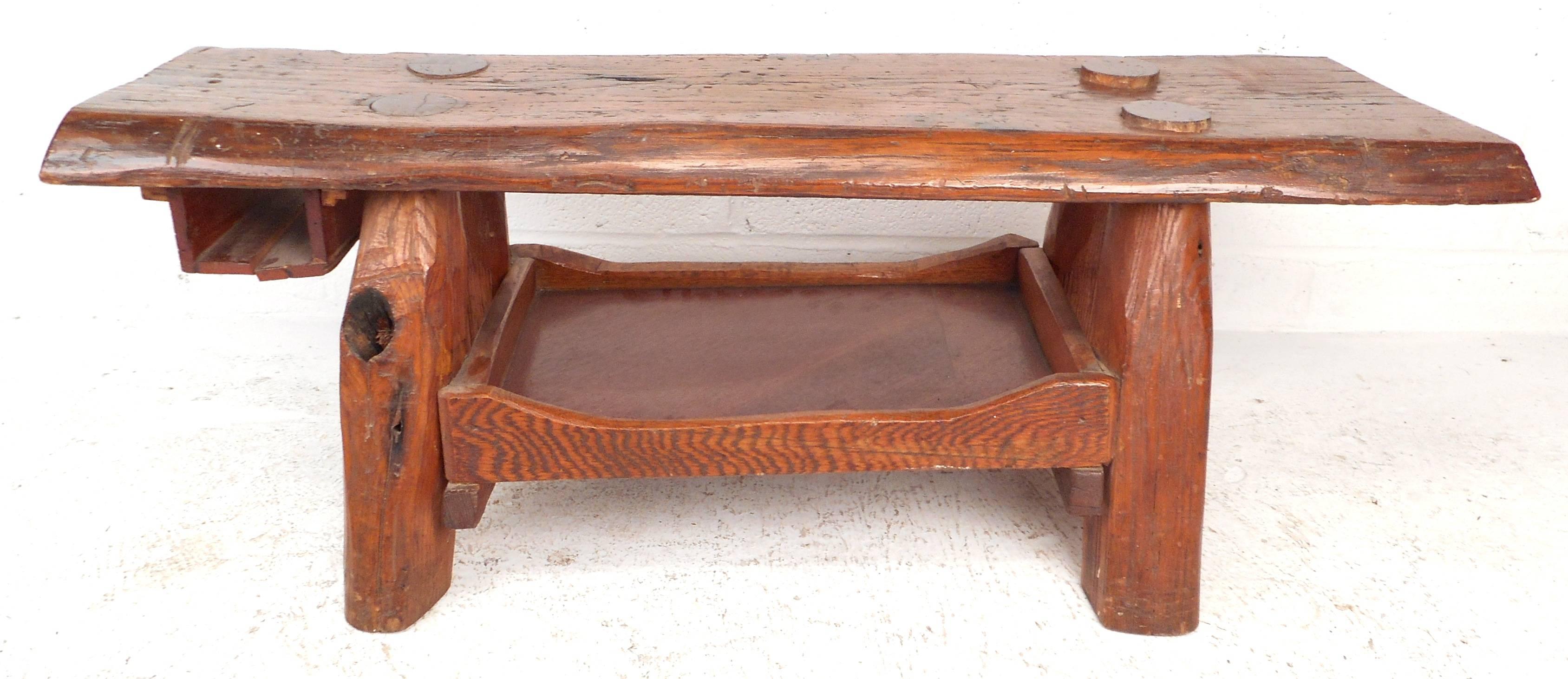 Unique rustic vintage cobbler's bench features a thick tree slab mounted on splayed legs with convenient storage underneath. Stylish look and versatile deign make this a unique piece for use as a coffee table or bench in any interior. Please confirm