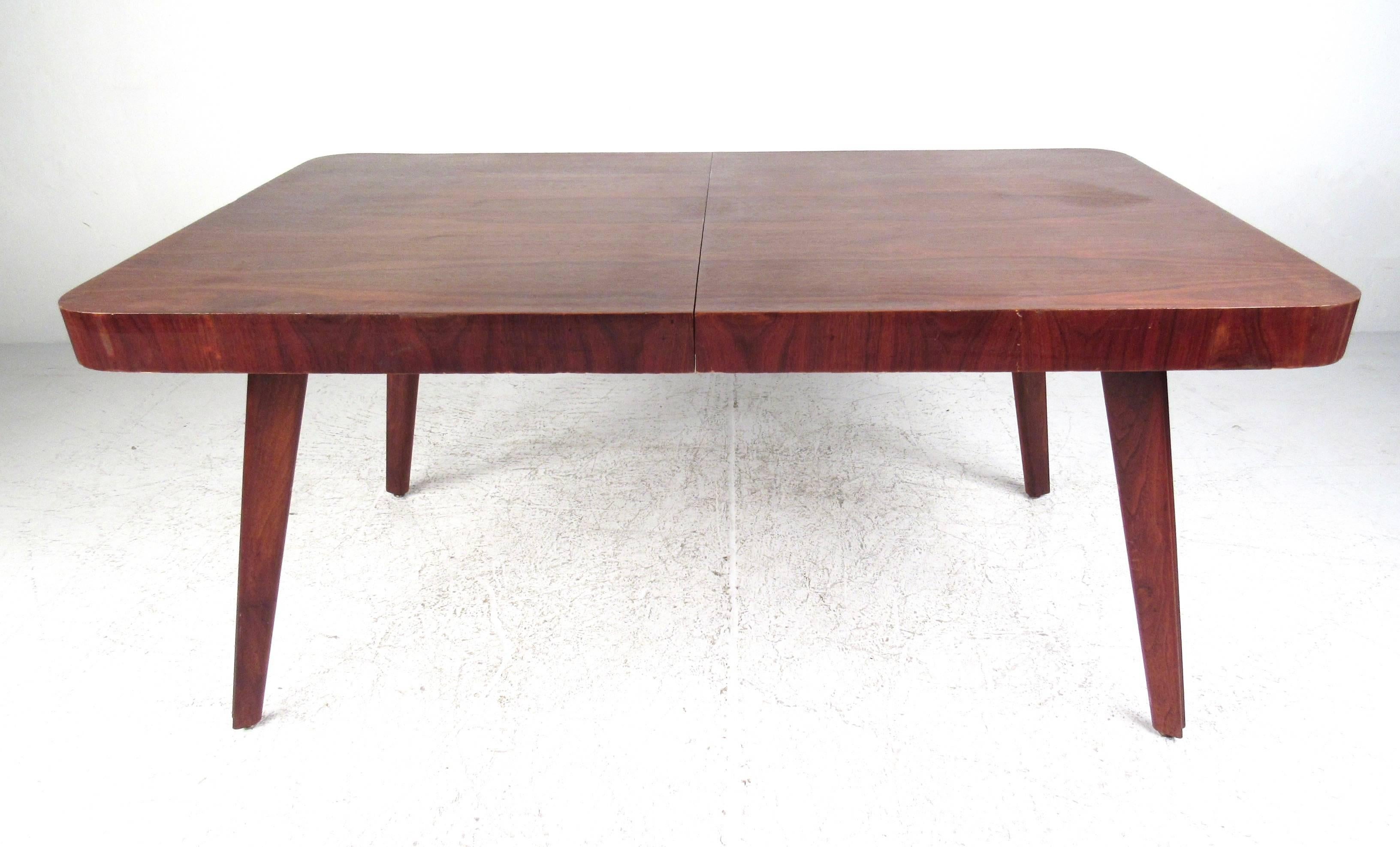 This uniquely sized vintage dining table comes matched with a set of six vintage dining chairs. Wonderful Mid-Century design exemplified with the stunning sculpted legs shared by both table and chairs. Comfortable seats for dining room use, perfect