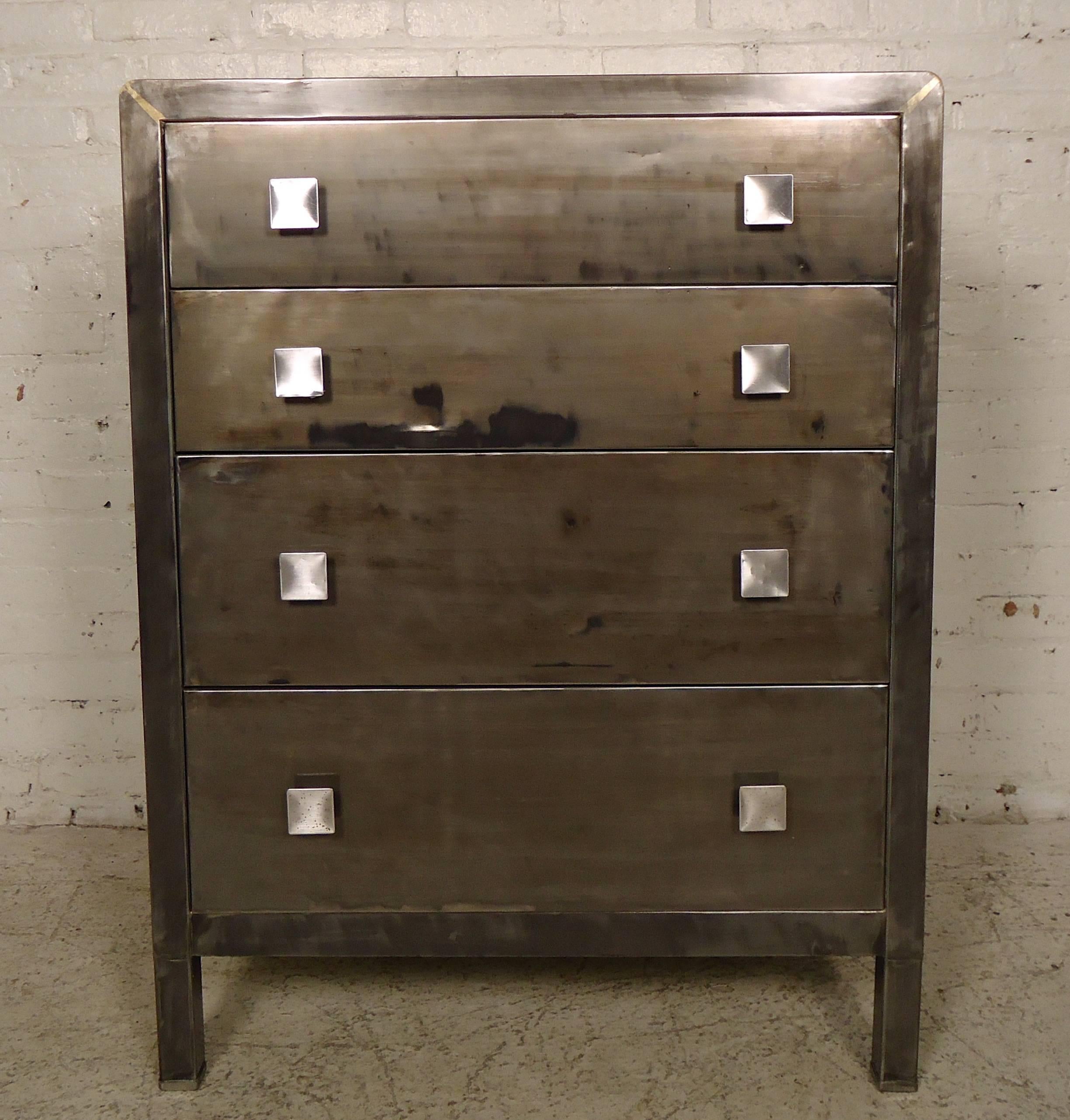 Mid-Century Modern designed dresser with four wide drawers with square handles. We have refinished this dresser in a bare metal style finish, giving a unique Industrial flair. 

(Please confirm item location NY or NJ with dealer).
