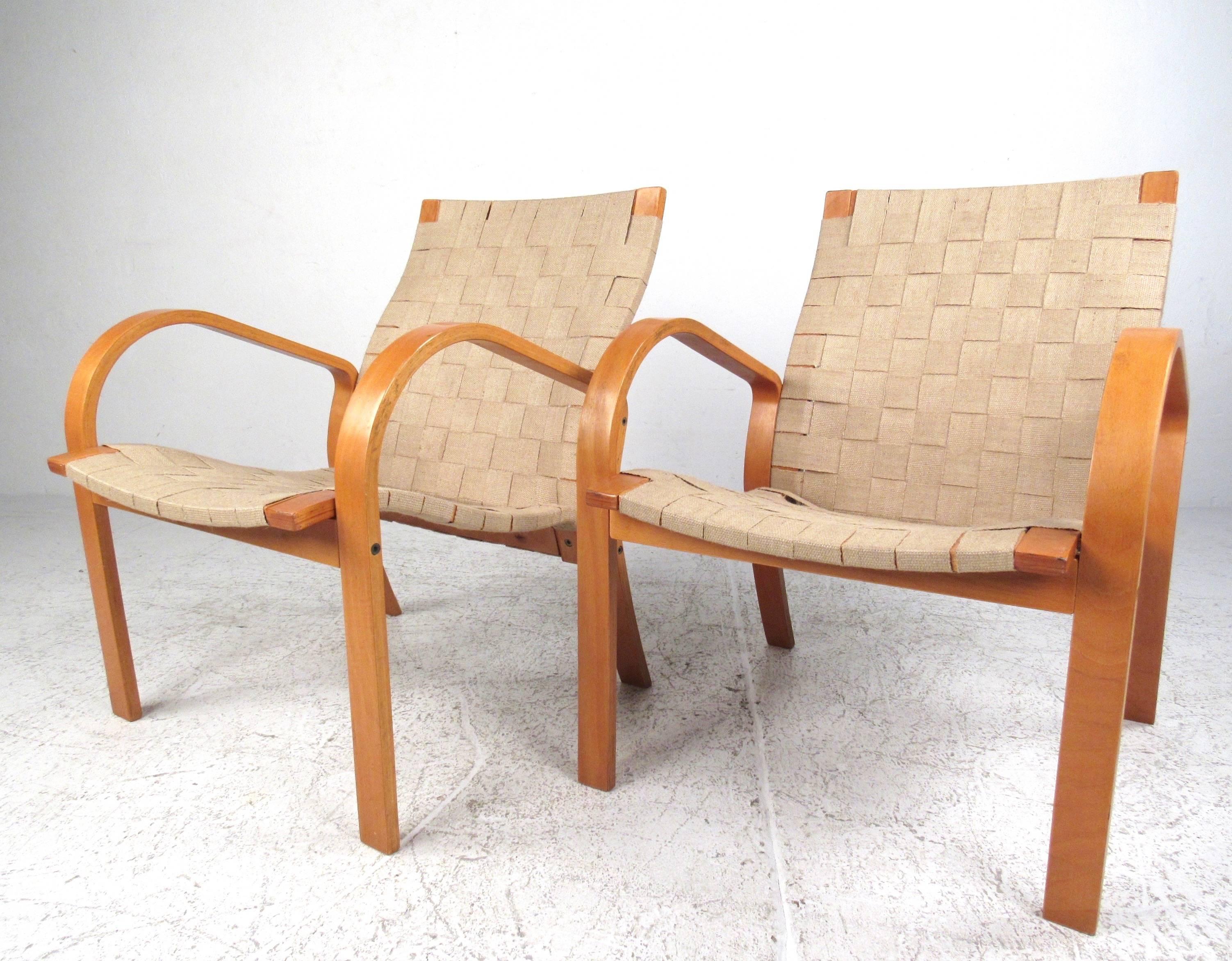 This pair of vintage molded wood armchairs feature the Scandinavian Modern style of Alvar Aalto. Linen strap webbing makes a comfortable and sturdy seat, while the flowing lines of the molded wood frame add to it's Mid-Century appeal. Please confirm