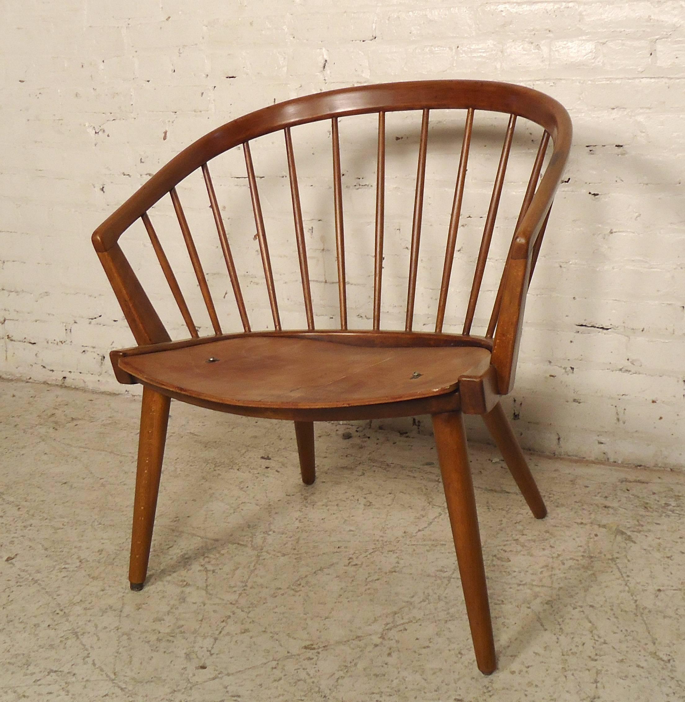 This beautiful Mid-Century Modern chair is made of rich teak grain in this Hans Wegner style frame. Stands on tapered legs, has a wide seat and rounded back rest with round spindles.

Please confirm item location (NY or NJ.)