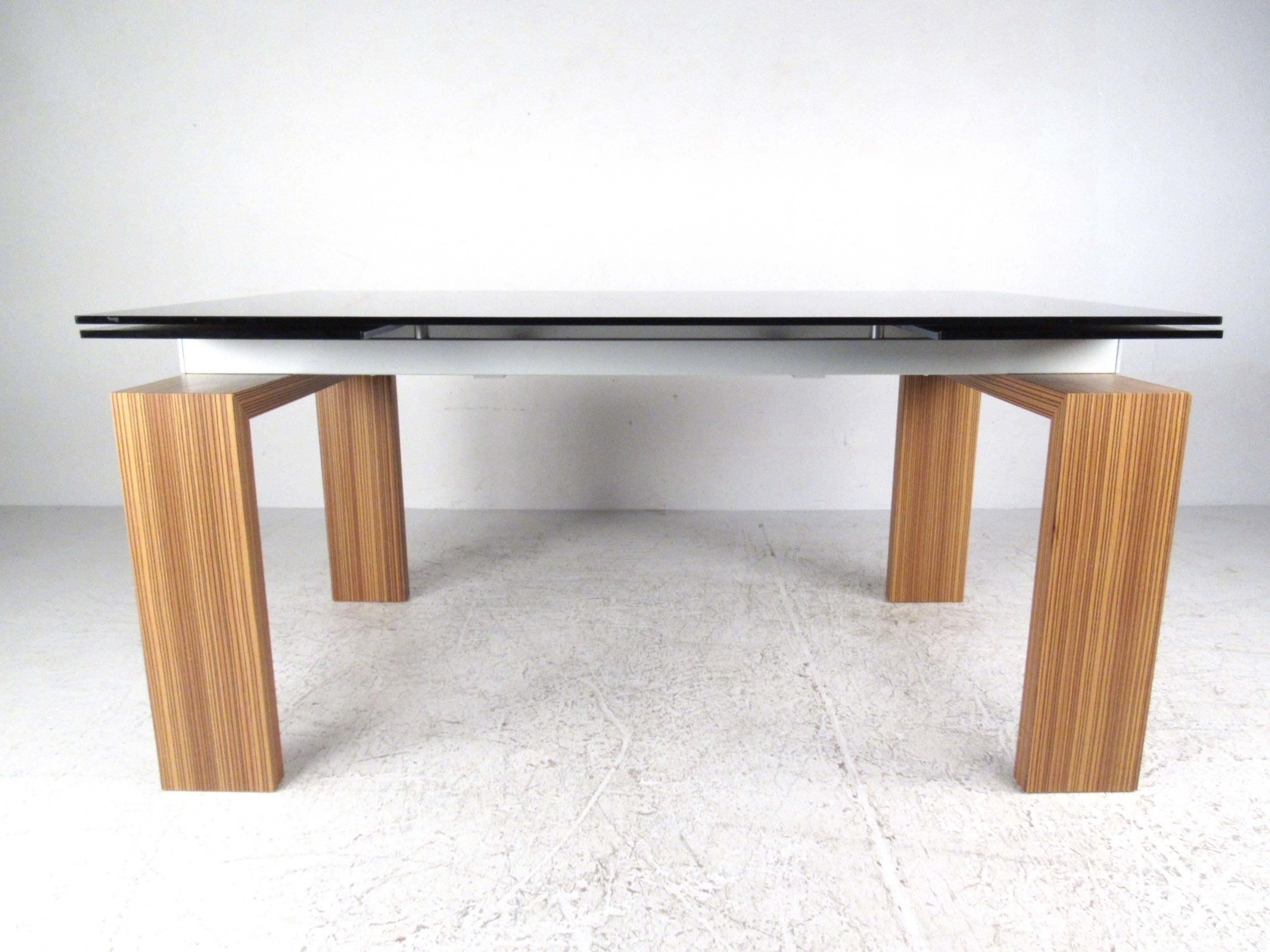 This beautiful contemporary Italian dining table by Tonin Casa features a floating top design with unique draw leaf table extensions. This stylish and versatile table boasts high quality luxury design and construction, making this unique table a