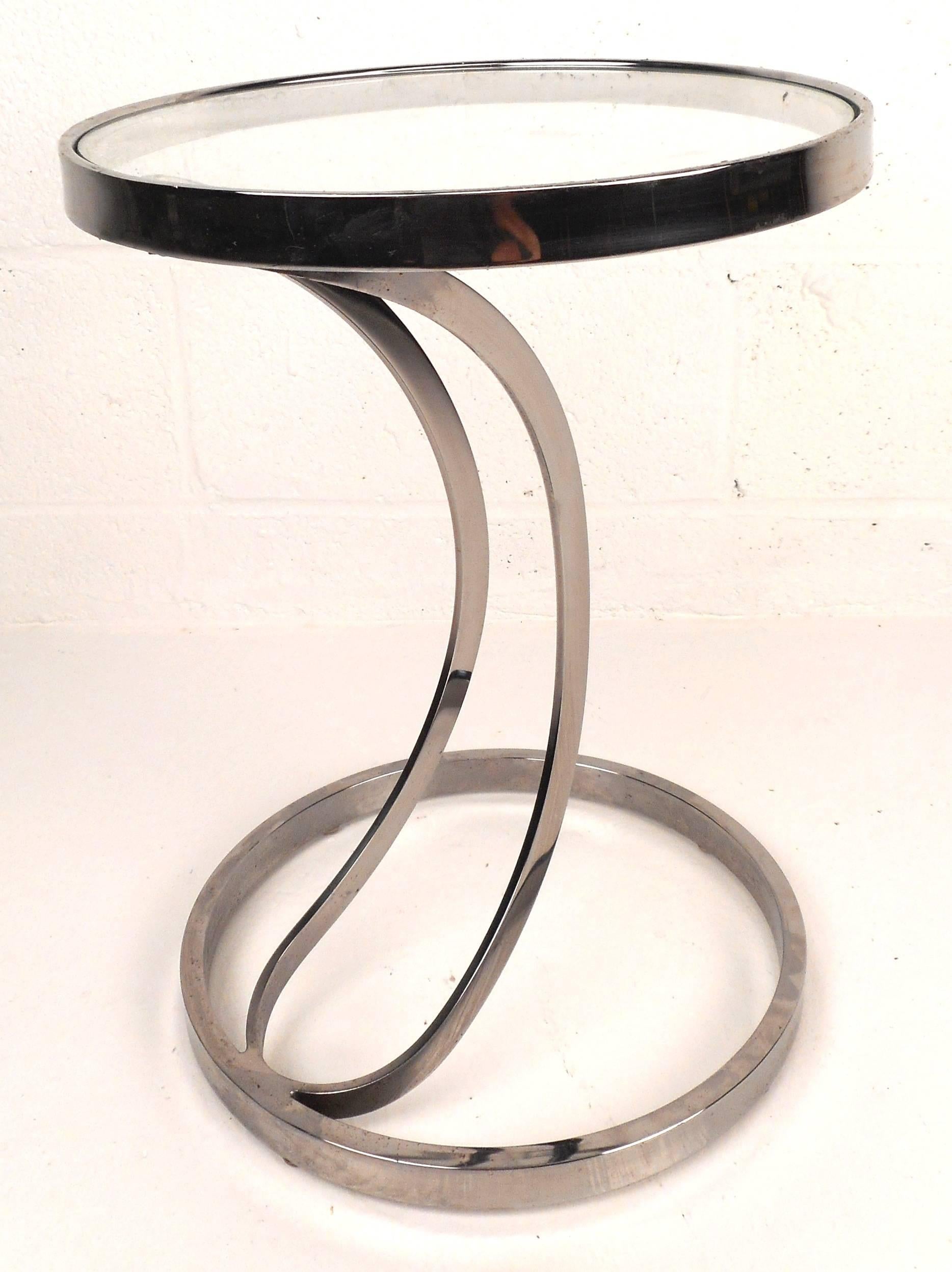 Stunning vintage modern end table features a heavy chrome frame, a unique circular floating top and a round open chrome base. The sleek sculpted middle supports stretch vertically from bottom to top providing sturdiness and style in any modern