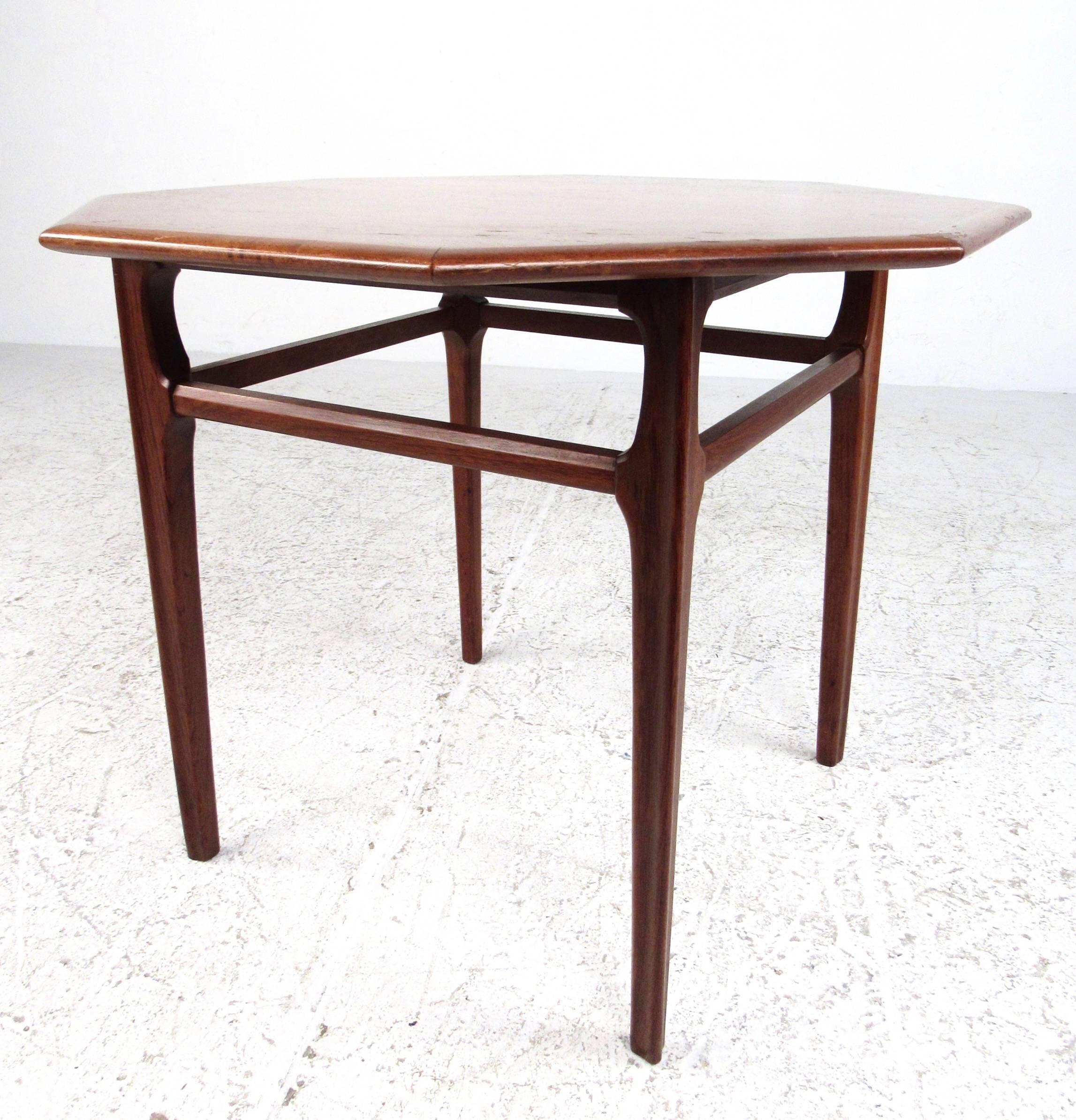 This vintage modern American walnut side table features a sculpted octagonal shape, gorgeous vintage wood finish, and tall slender legs. Four way stretchers add stability to this perfect sofa end table. Great occasional table for home or office.