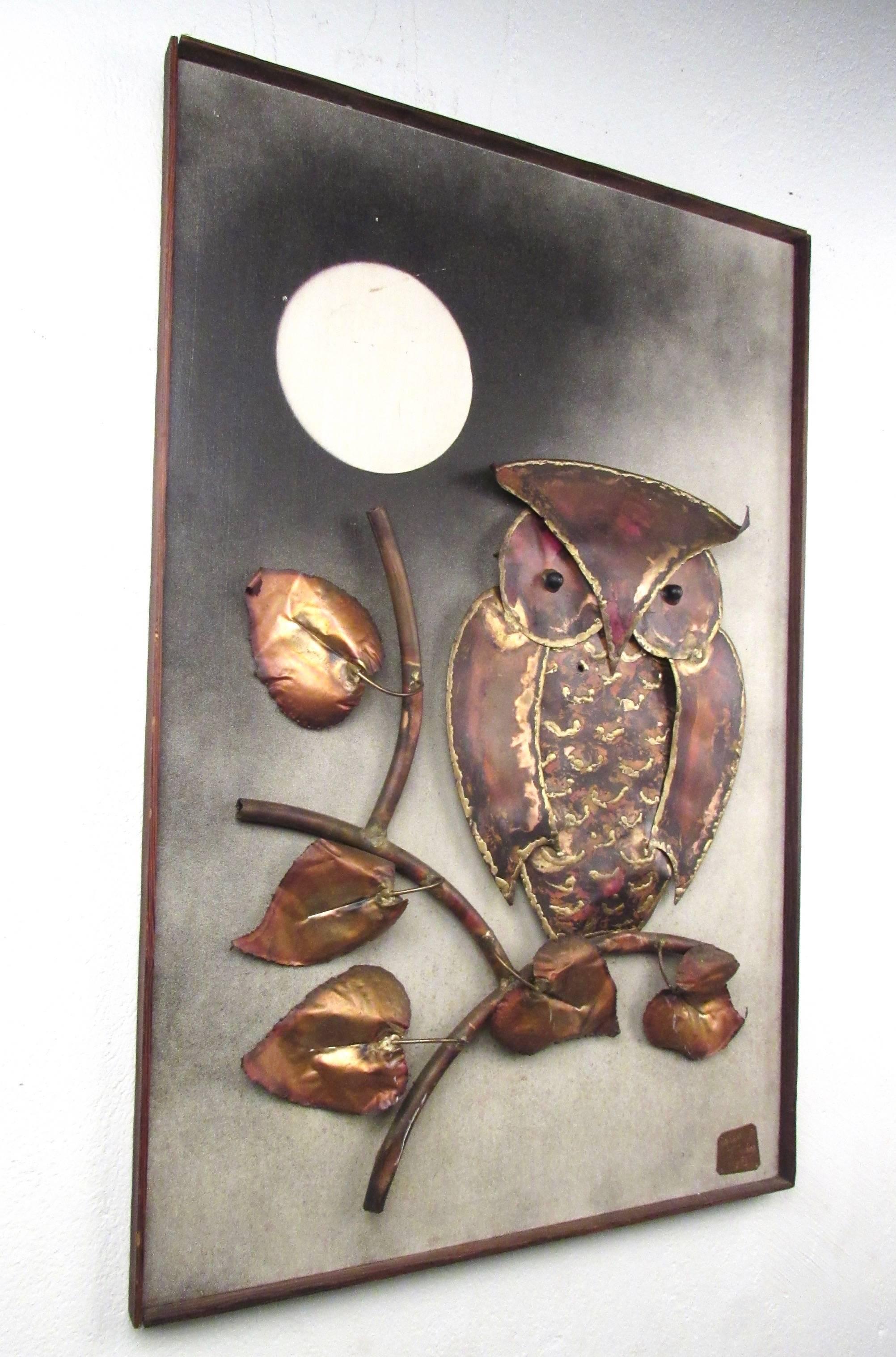 This unique mixed-media wall art piece depicts an owl sitting in the moonlight and is sculpted from hammered metal, mounted to painted back board. Wonderful Mid-Century style in this signed 1970s work of art by Hungarian artist Alex Kovacs. Please