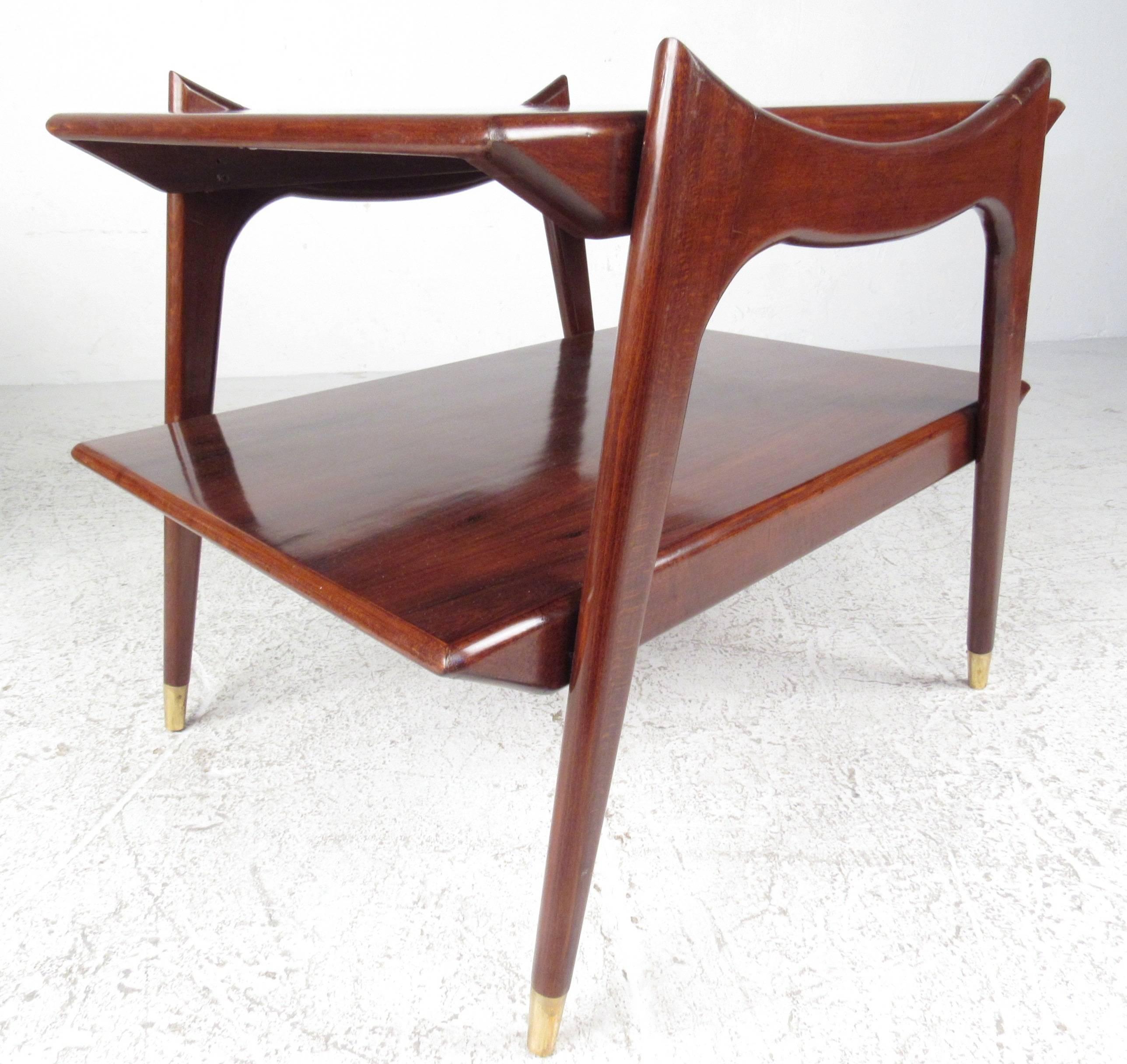 Gorgeous Italian style two-tier end tables with sculpted sides and capped feet. Made with rich rosewood grain and tapered legs, these tables make great sofa tables with extra storage underneath.

(Please confirm item location - NY or NJ - with