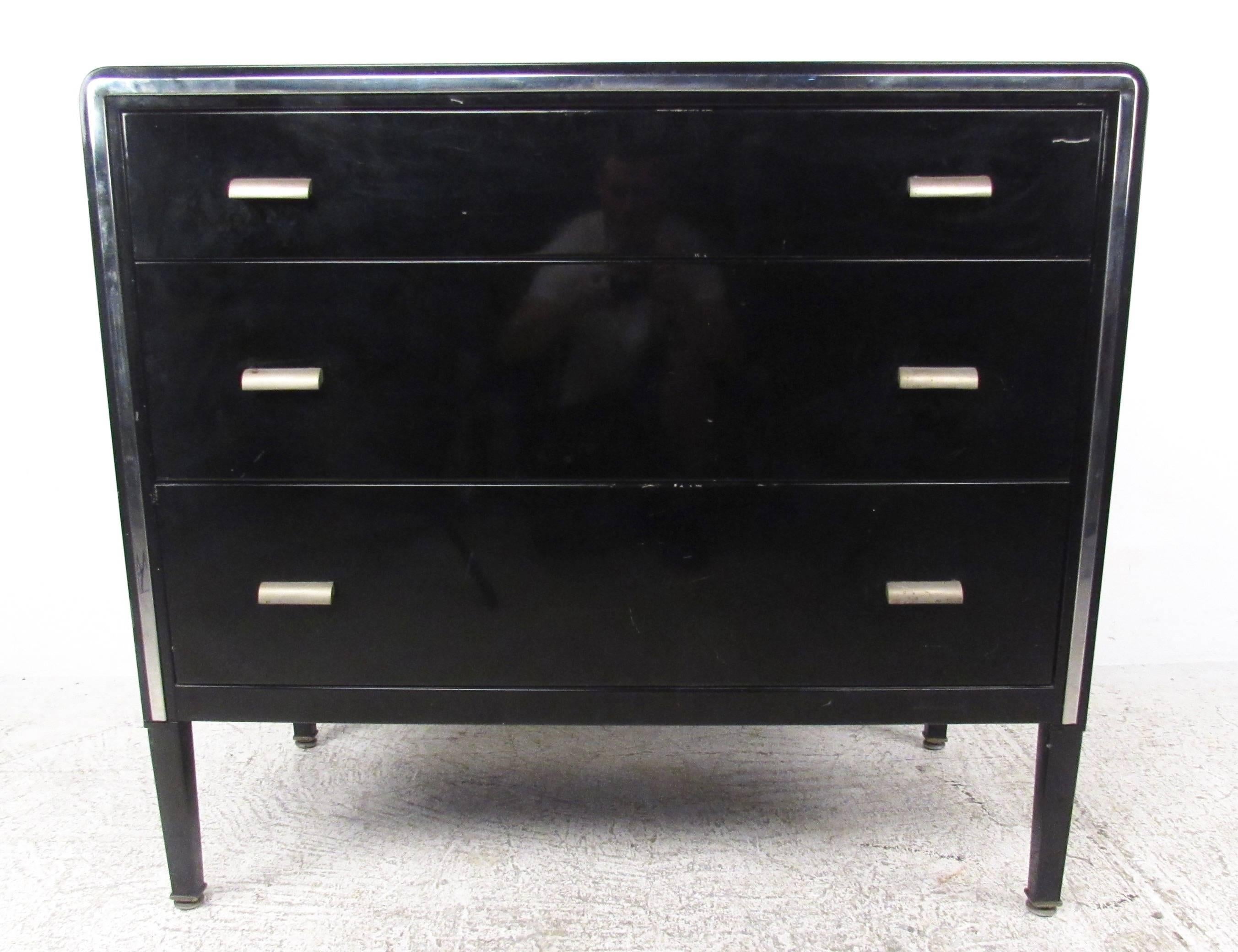This vintage metal dresser with matching end tables by Simmons Furniture make a lovely Mid-Century addition to any interior. Spacious drawers for storage and sleek black lacquer finish set this Industrial metal pair apart from others of the era.