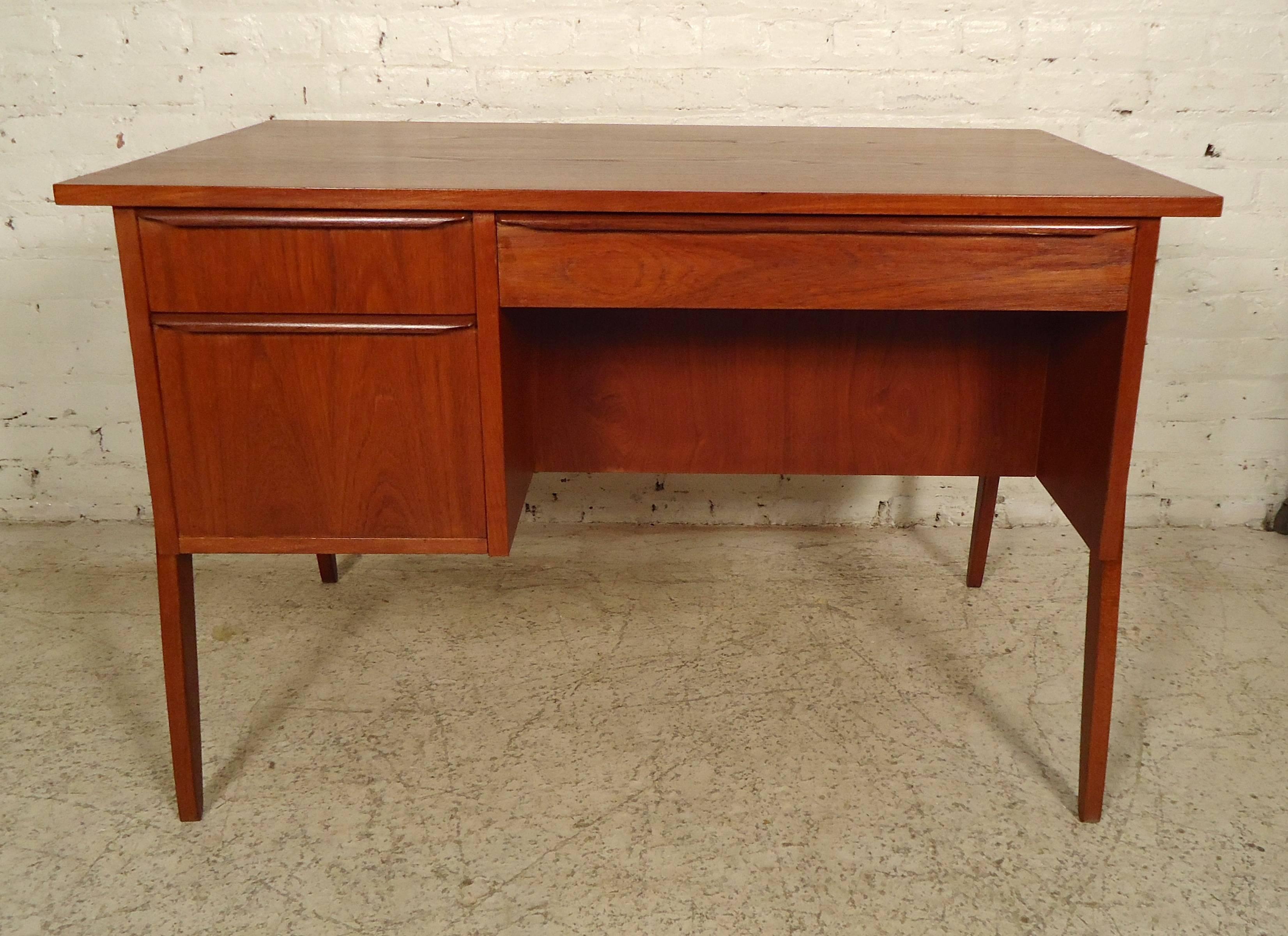 This unique vintage-modern desk comes with many features, such as a pull-out vanity mirror, front drawer, and storage unit. The back also has a set of drawers with hand-carved handles; the table rests on splayed legs.

(Please confirm item