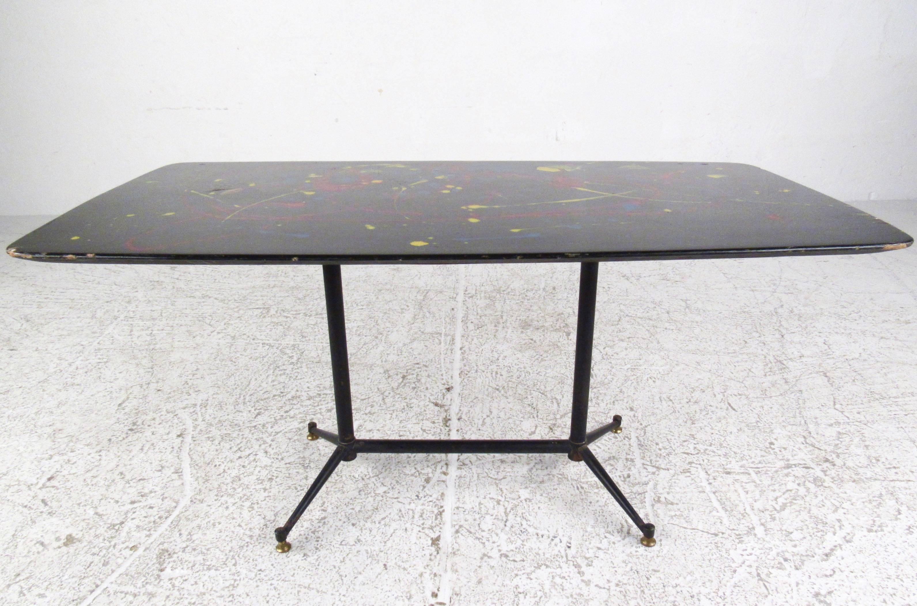 This unique Mid-Century Modern Italian coffee table features a sleek and stylish metal base with multi-color painted top. Perfect cocktail height and petite size make this an ideal table for a variety of seating settings. Please confirm item