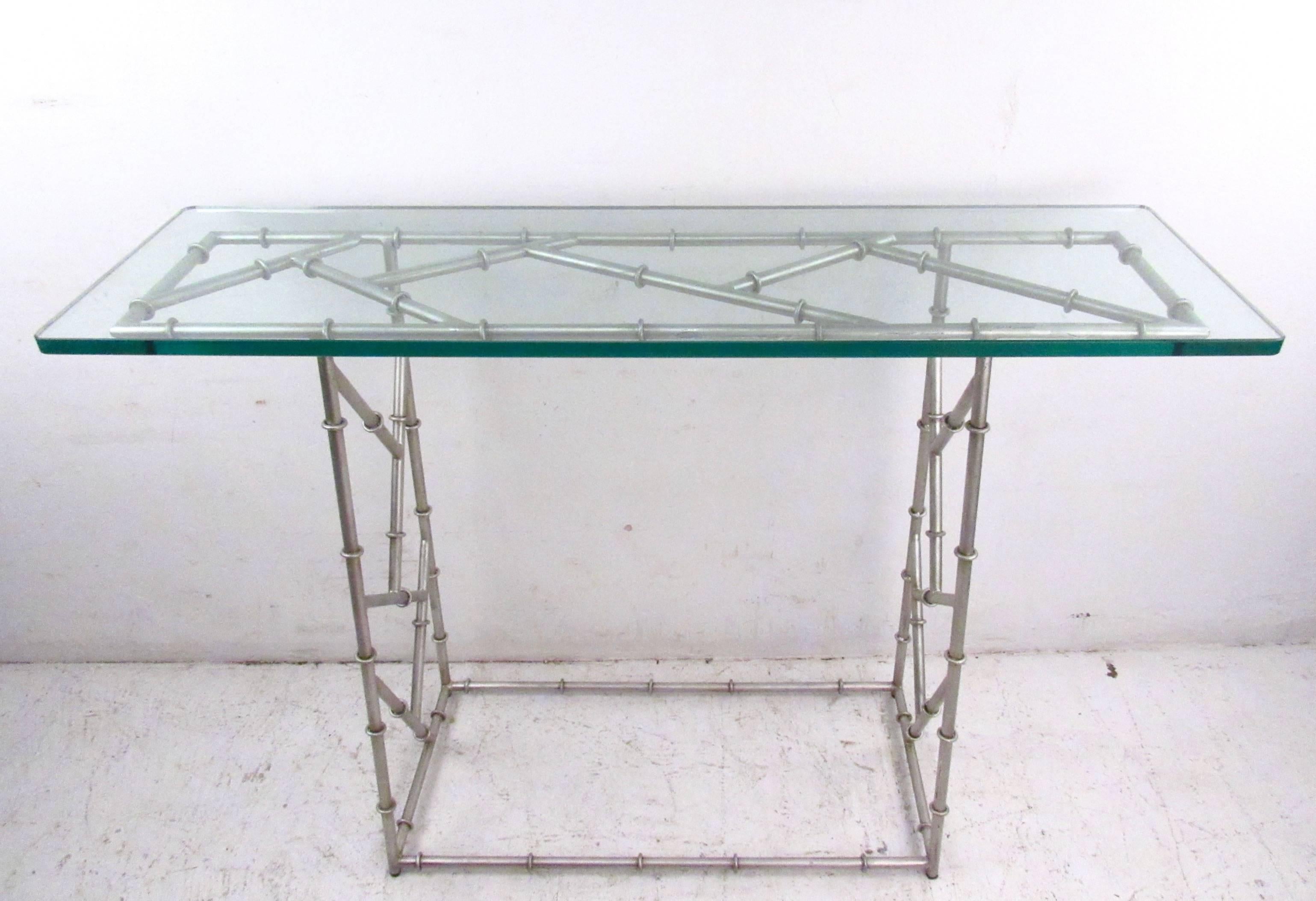 This faux bamboo console table features a sturdy metal frame base with glass top. Unique decorator's table offers a simple yet versatile design perfect for hall, entryway, or living room use. Please confirm item location (NY or NJ).